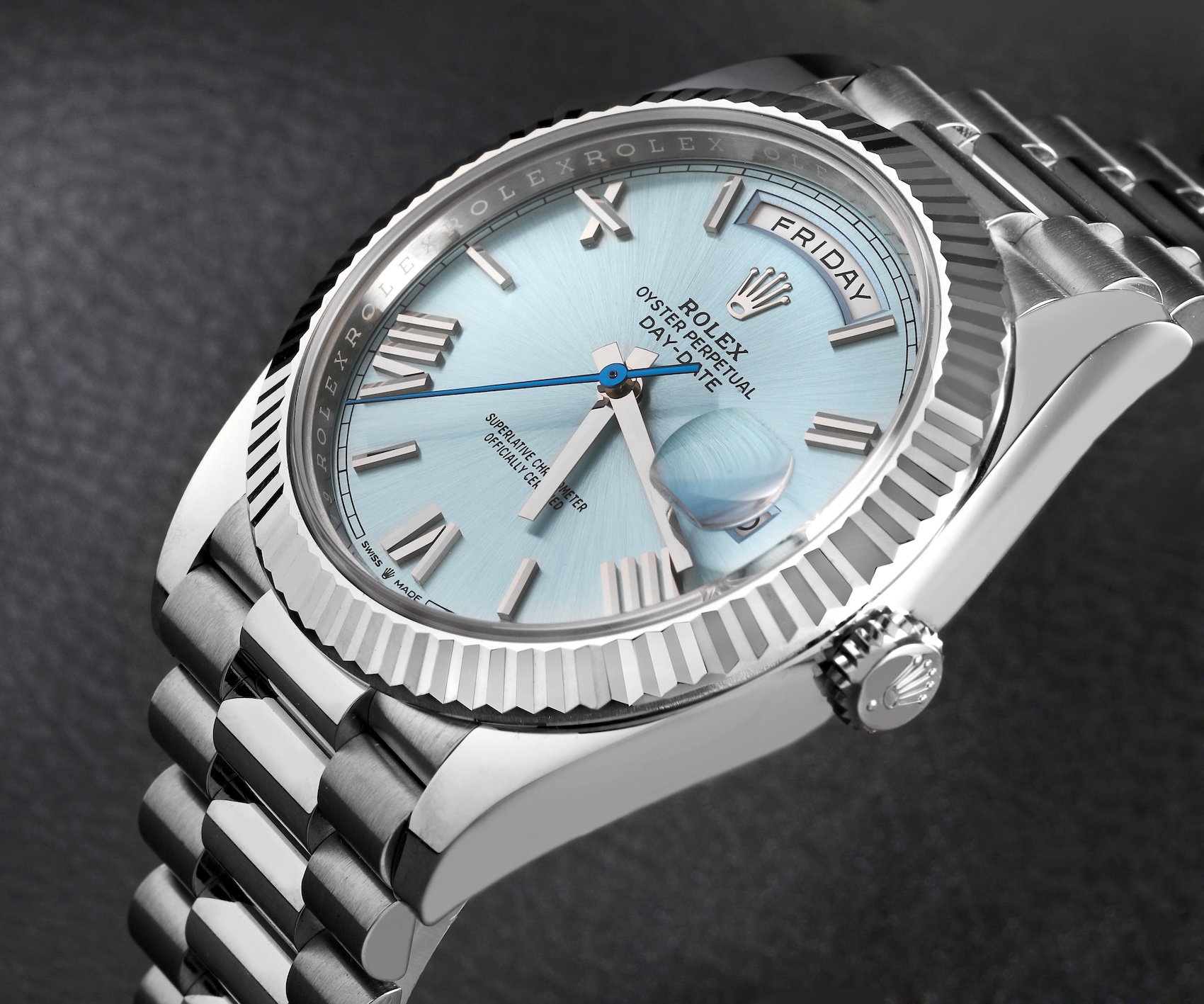 Platinum Rolex Day-Date ref 128236 with an ice blue dial showing a Twinlock crown marked with a single dot.
