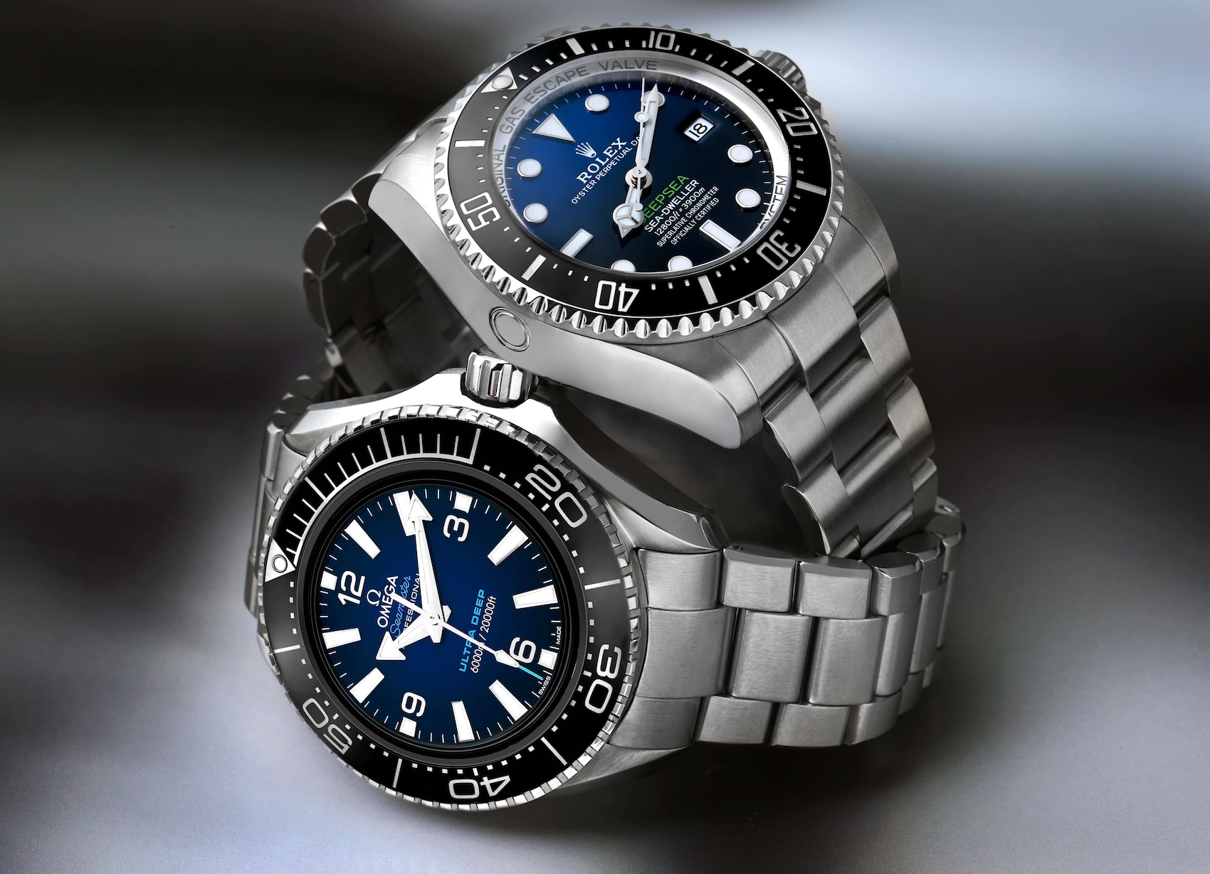 A Rolex Deepsea D-Blue stacked on top of an Omega Seamaster Planet Ocean Ultra Deep, showing the rivalry between the two top dive watches.