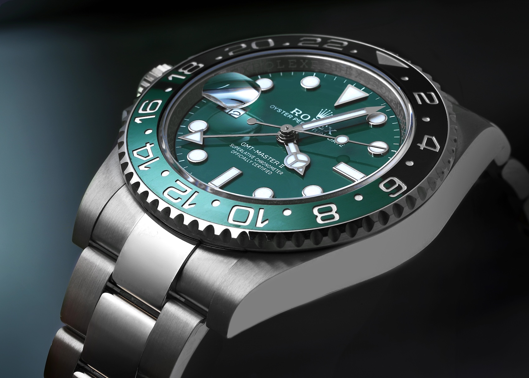 Close-up of the 18k white gold Rolex GMT-Master II Sprite, highlighting the vivid green lacquer dial and matching green and black ceramic bezel.