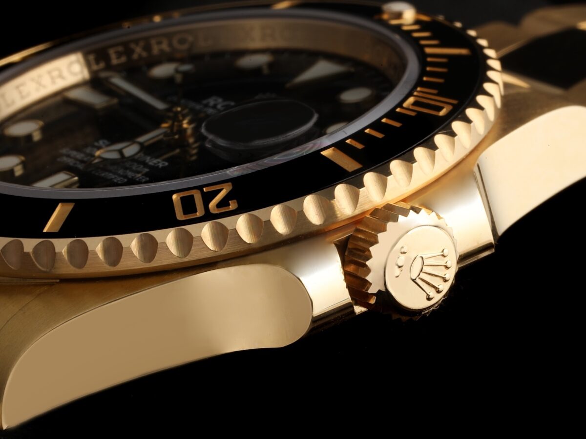 Solid 18k yellow gold Rolex Submariner ref 126618 showing the Triplock winding crown with three equal dots.