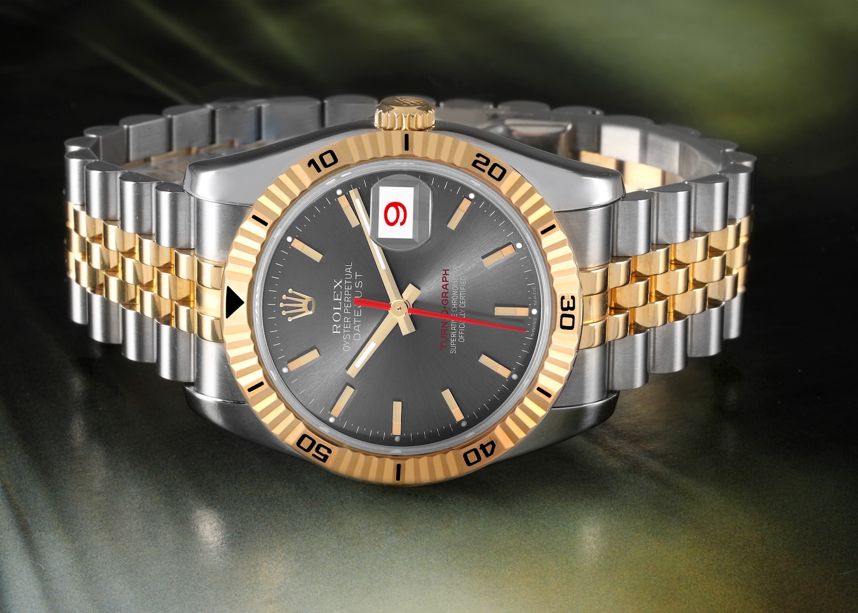  Rolex Turn-O-Graph Datejust showing a striking red date numeral on a gray dial.
