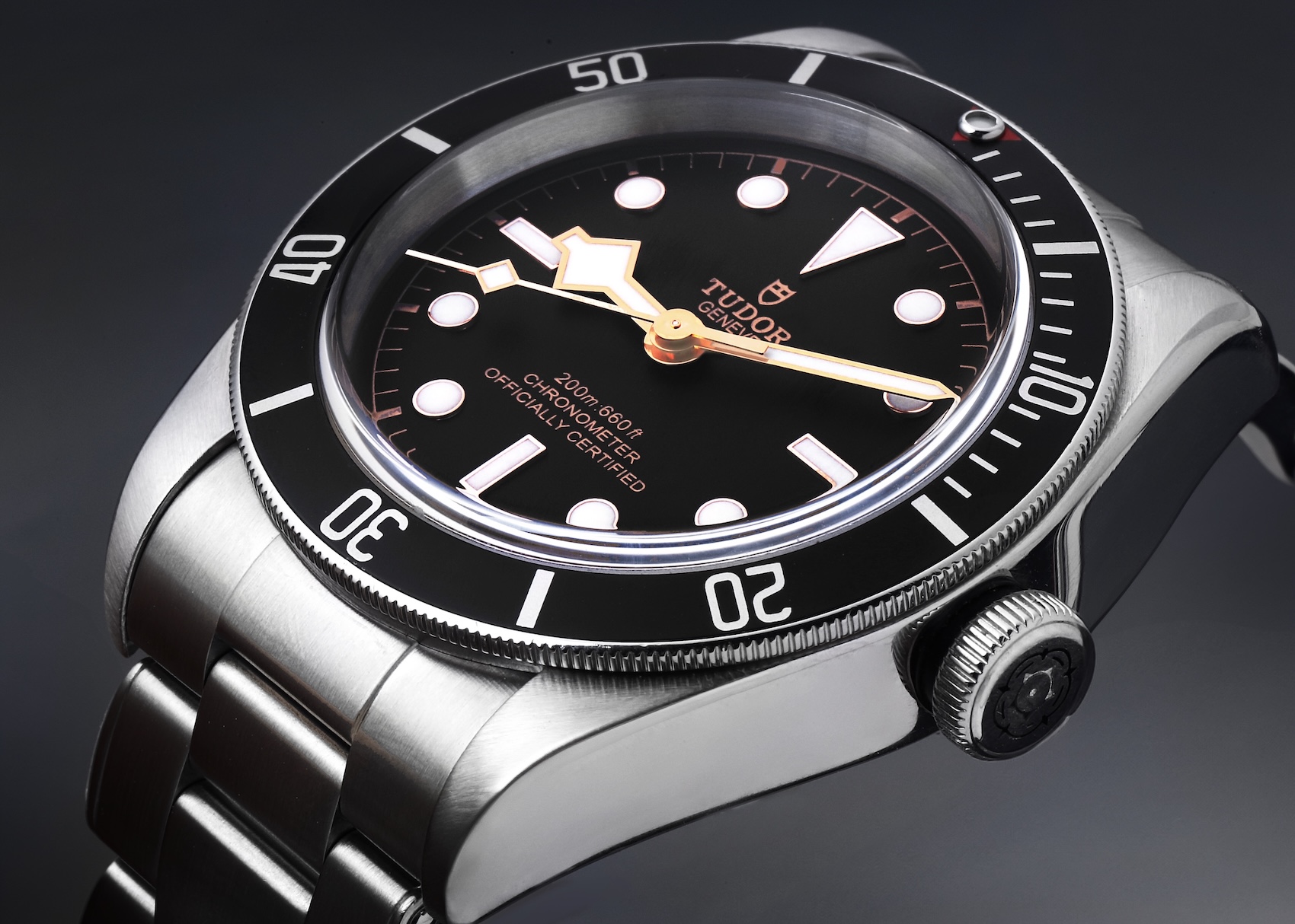 Close-up of Tudor Black Bay 58 black dial on riveted steel bracelet.