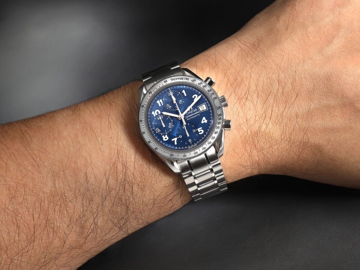 Omega Speedmaster Date 39mm with blue dial worn on a wrist.