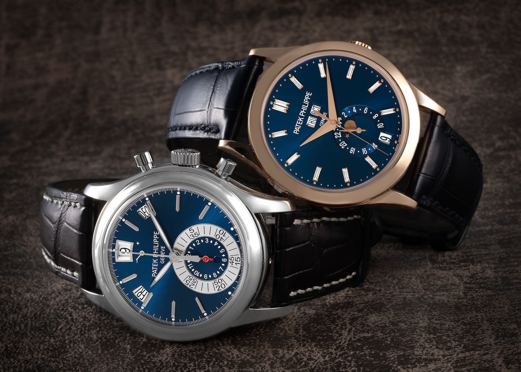 Two Patek Philippe Complications watches side by side: a platinum Ref 5960P chronograph with a blue dial and a rose gold Ref 5396R with a blue diamond-set dial.