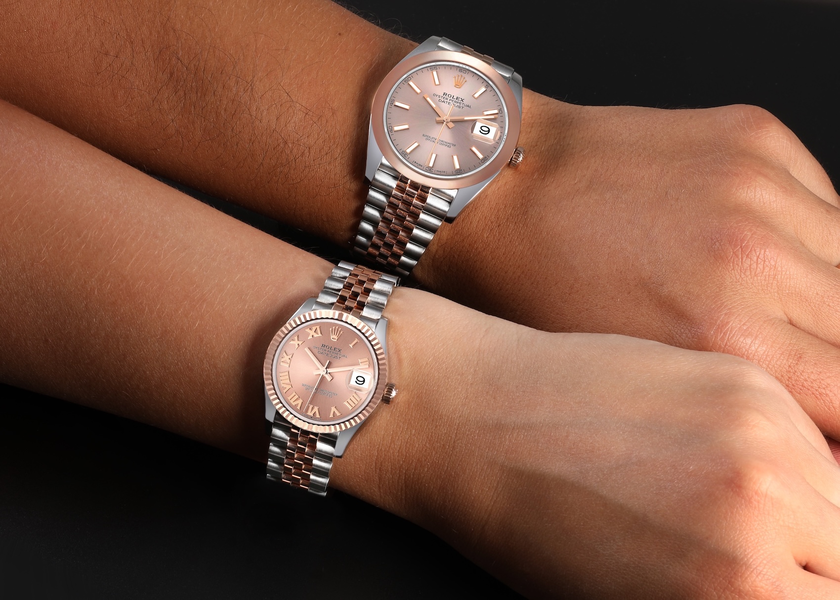  Two collectors wearing two-tone rose gold Rolex Datejust watches showing different case sizes.