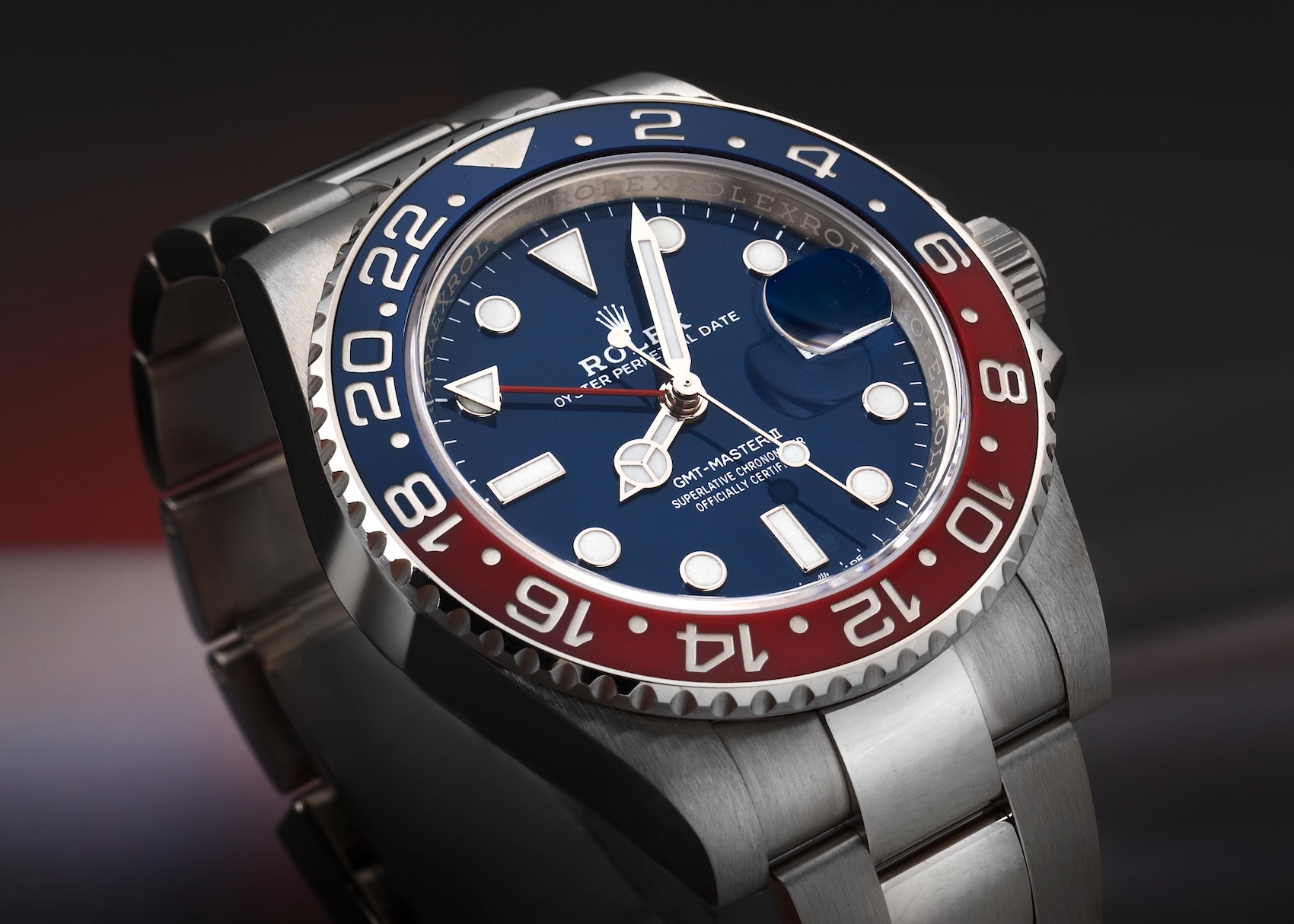 An angled view of the 18k white gold Rolex GMT-Master II Pepsi (Ref. 126719BLRO) featuring the ceramic bezel, Oyster bracelet, and a distinct blue dial.