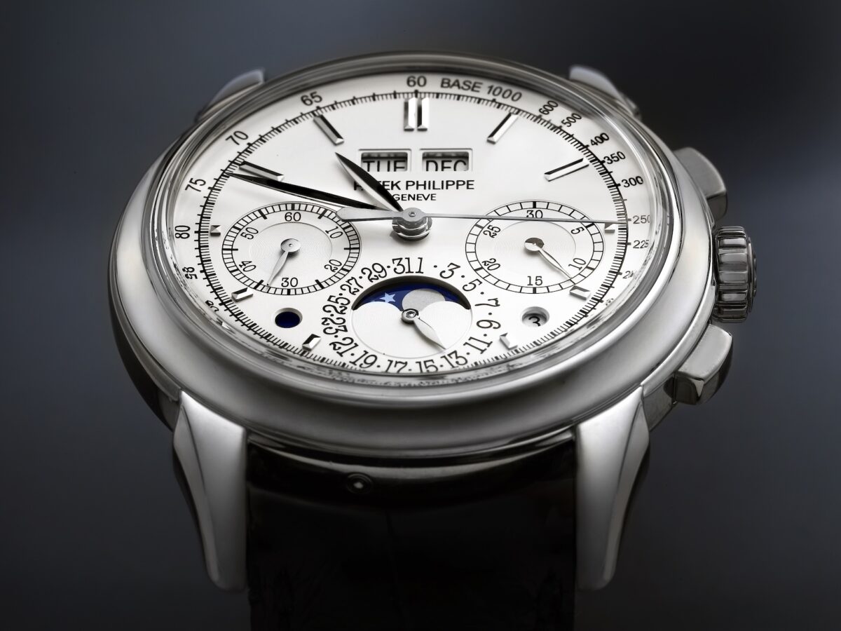 Close up macro shot of the white gold Patek Philippe 5270G perpetual calendar chronograph dial showing the moon phase and day month apertures.
