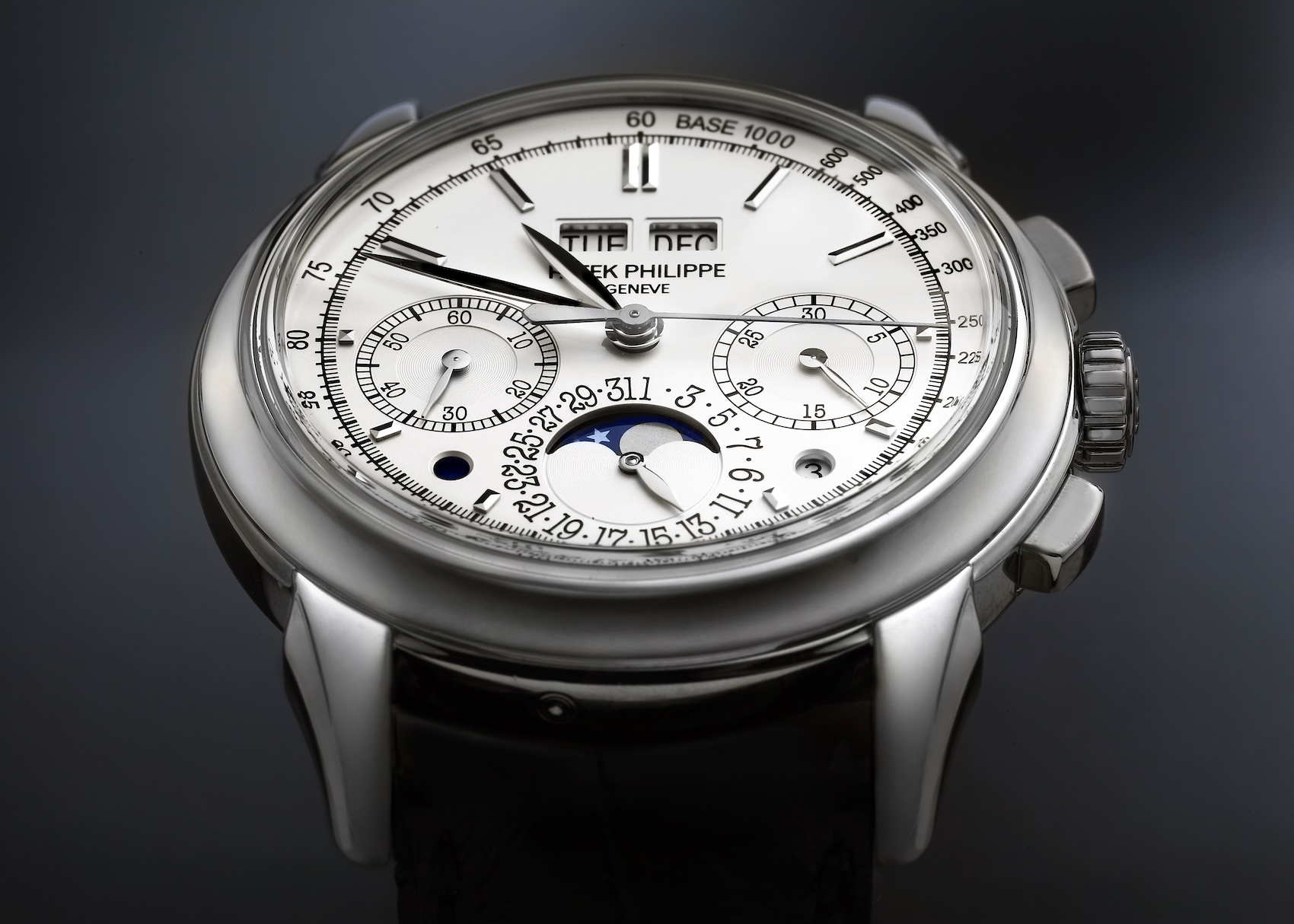 Close up macro shot of the white gold Patek Philippe 5270G perpetual calendar chronograph dial showing the moon phase and day month apertures.