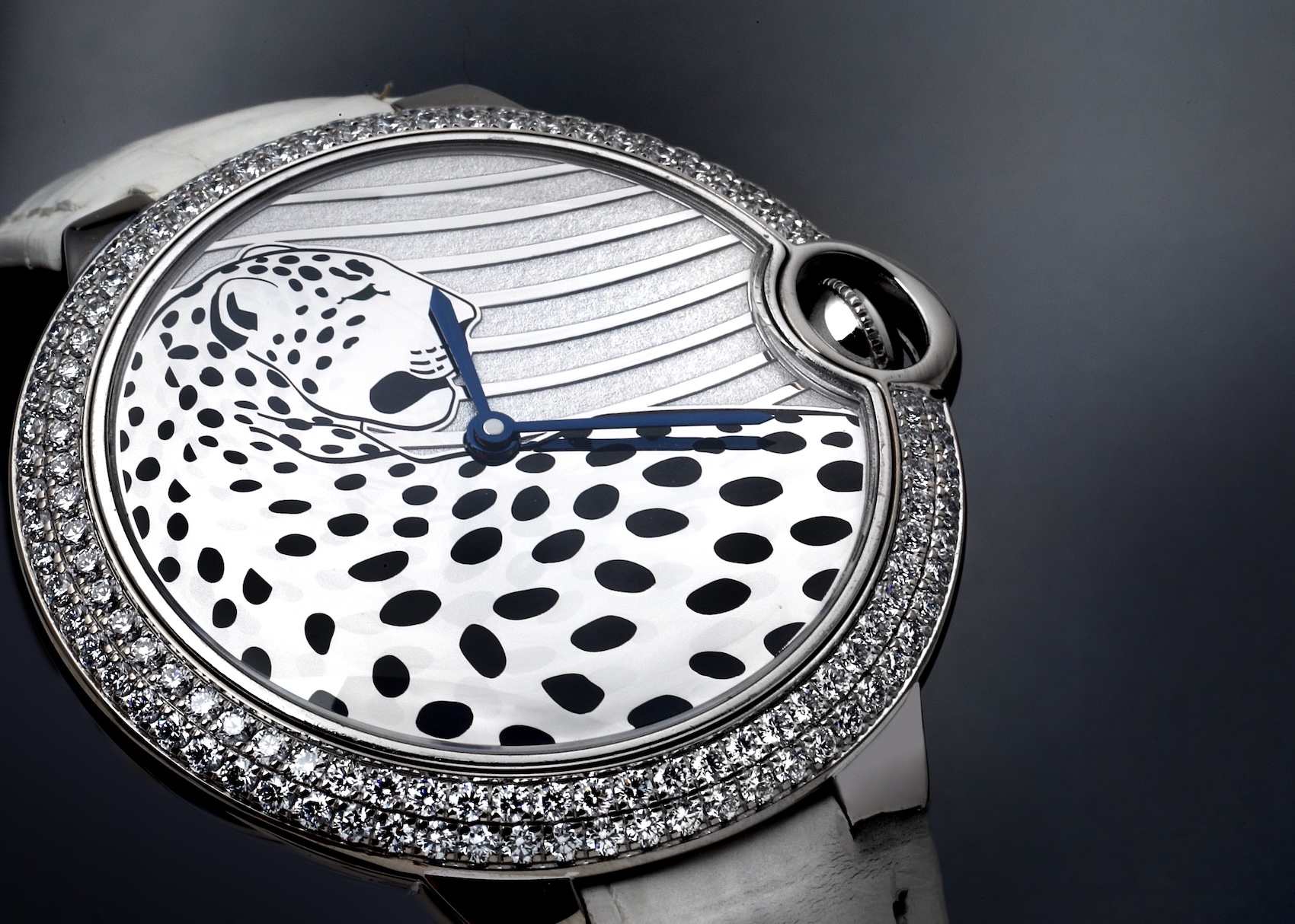  Close-up of Cartier Ballon Bleu Panthere dial featuring a white gold panther motif and diamond-set bezel.