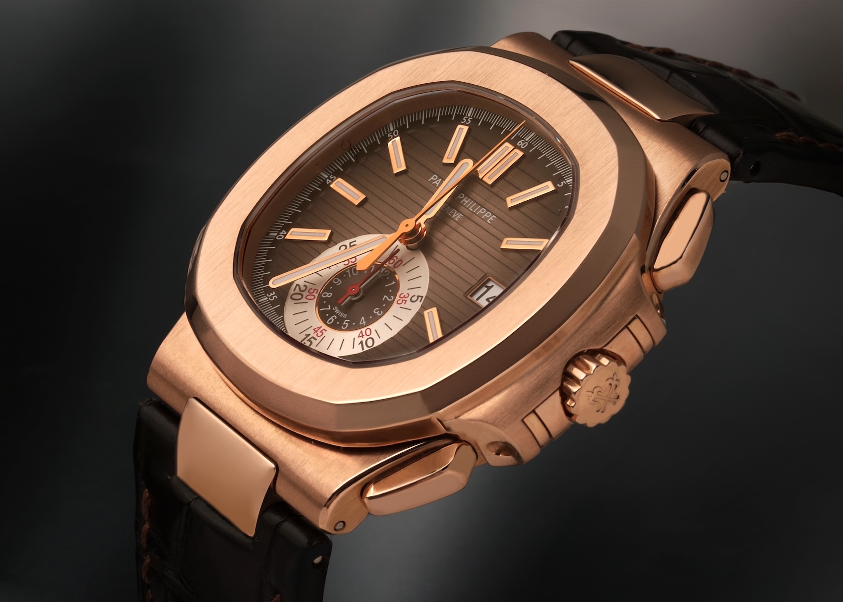 Angled side profile of the rose gold Patek Philippe Nautilus 5980R, showcasing the integrated flyback chronograph pushers and iconic octagonal bezel.