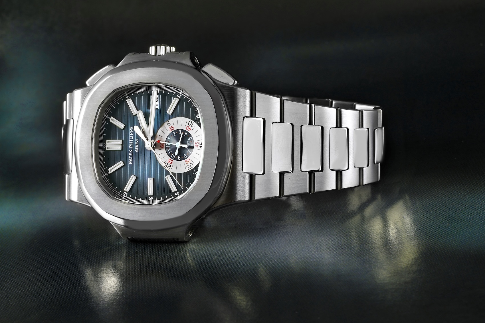 Full view of the stainless steel Patek Philippe Nautilus Chronograph Ref 5980/1A-001 with the classic blue gradient dial and integrated steel bracelet.