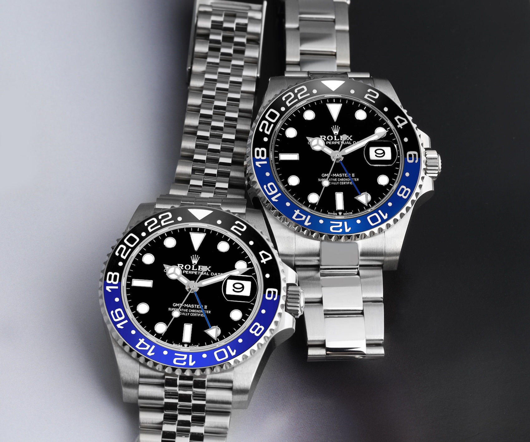 Two Rolex GMT-Master II blue and black bezel watches, one on an Oyster bracelet known as the Batman, and one on a Jubilee bracelet known as the Batgirl.