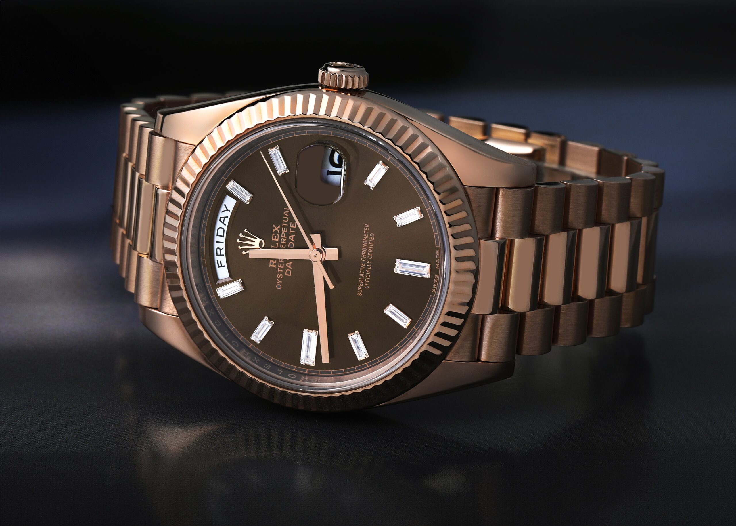 Rolex Day-Date 40 228235 in Everose gold with a chocolate brown sunray dial and baguette diamond indices.