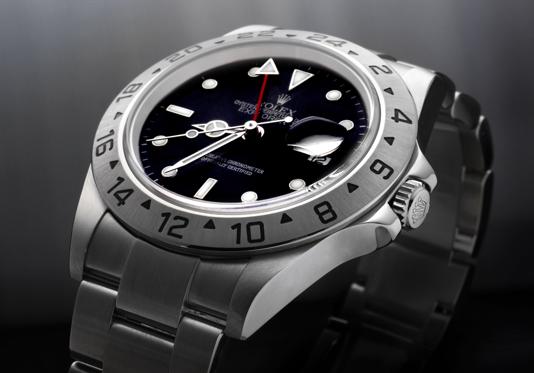 Neo-vintage Rolex Explorer II Reference 16570 with a glossy black dial, red GMT hand, and fixed 24-hour steel bezel.