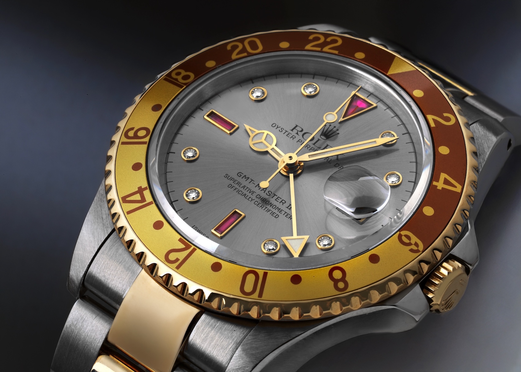 Rolex GMT-Master II 16713 Serti dial featuring a slate grey sunburst background with factory diamond and ruby hour markers.