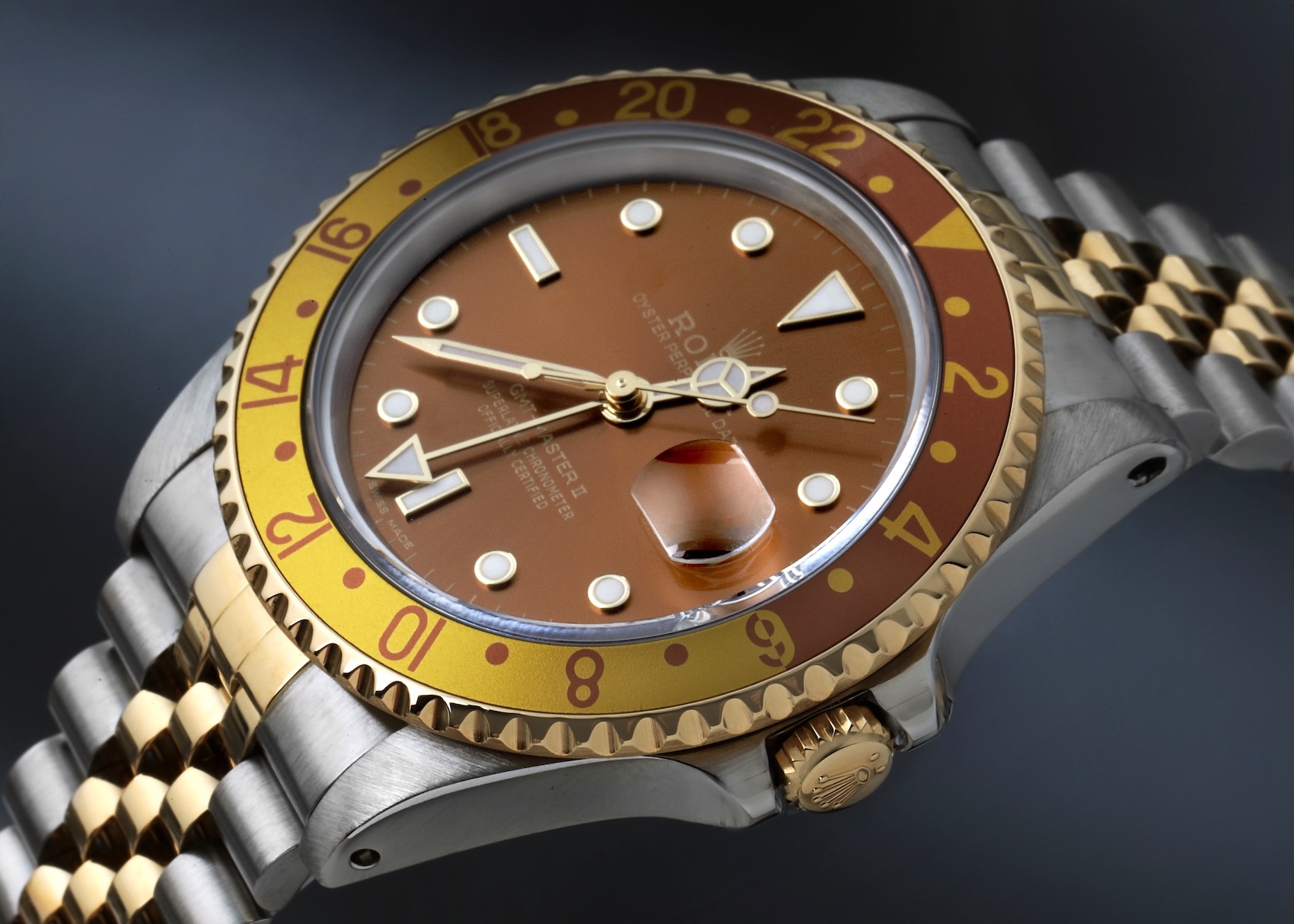Rolex GMT-Master II 16713 Root Beer mounted on a two-tone 18k yellow gold and stainless steel Jubilee bracelet.