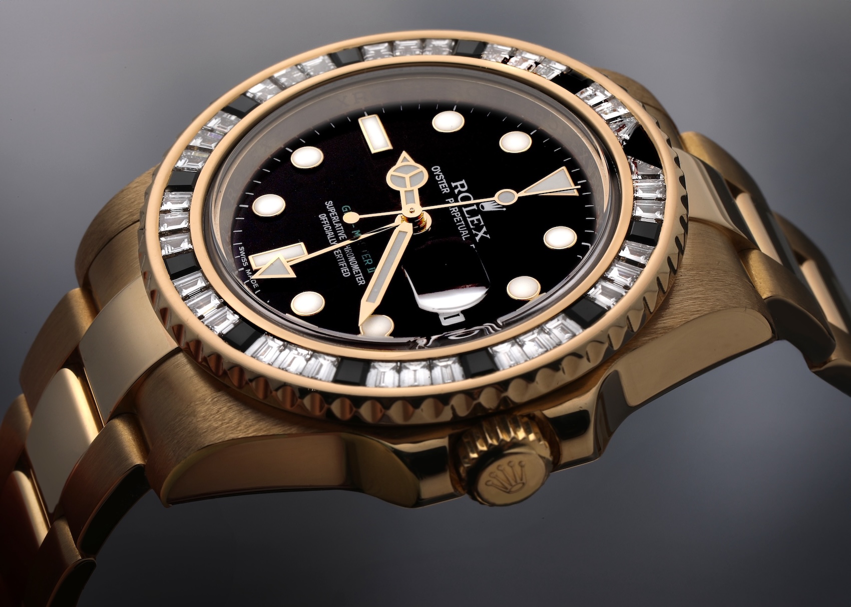 Rolex GMT-Master II in yellow gold with a SARU-style bezel featuring alternating baguette diamonds and black sapphires.