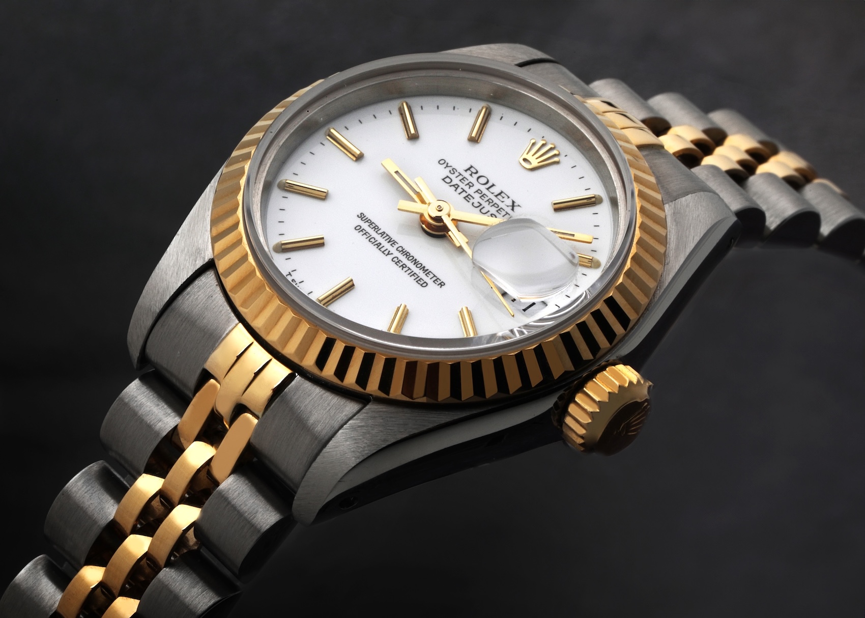 Two-tone Rolex Lady-Datejust Reference 79173 featuring a crisp white dial, yellow gold fluted bezel, and Jubilee bracelet.