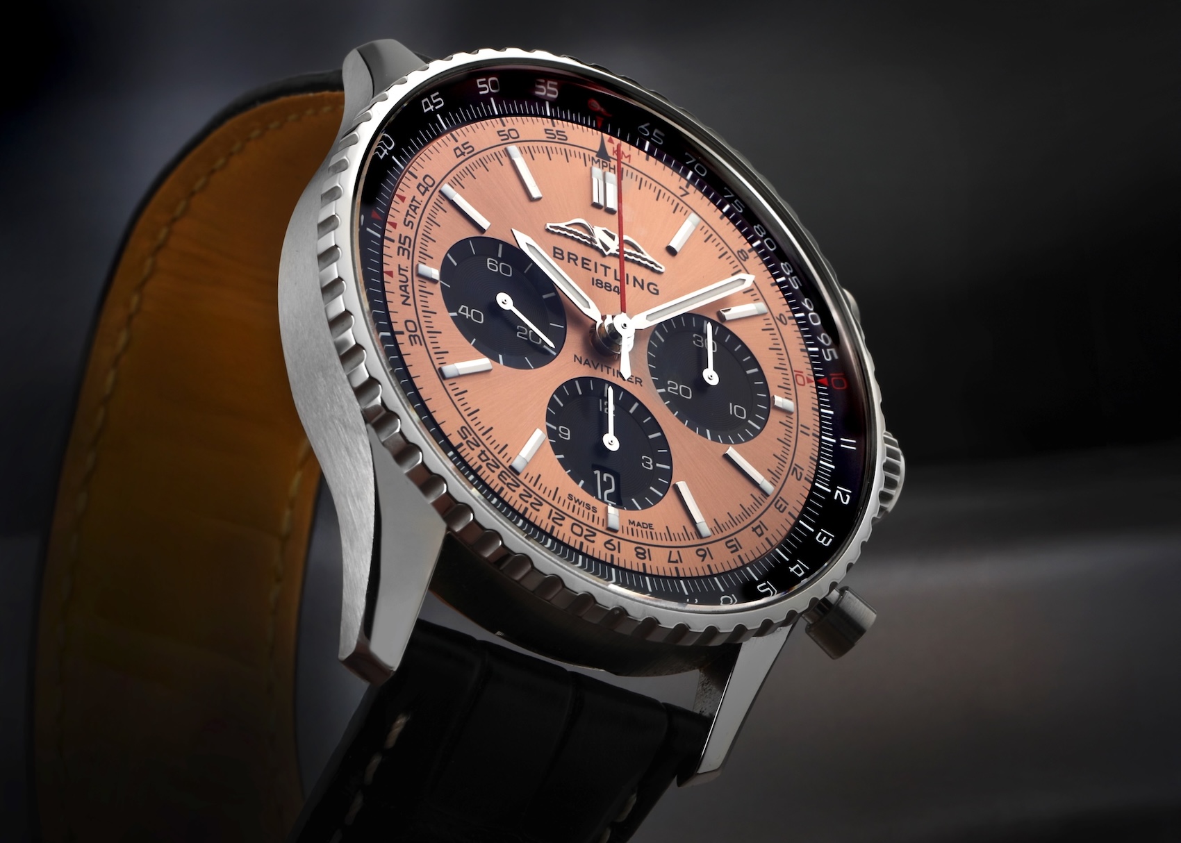 Angled view of the Breitling Navitimer B01 Chronograph Ref. AB0138 featuring a warm copper dial with black sub-dials and a slide-rule bezel.