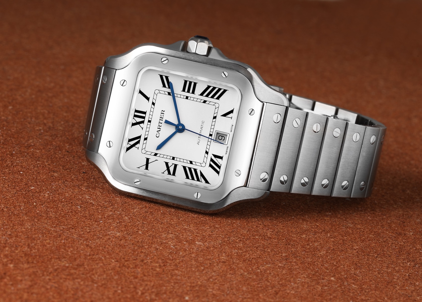 Cartier Santos de Cartier Large stainless steel watch with white square dial, black Roman numerals, blue hands, and exposed screw details on the integrated bracelet.