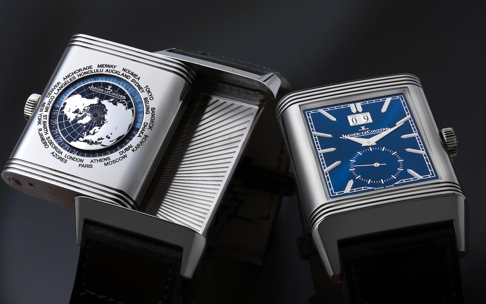 The dual-faced Jaeger-LeCoultre Reverso Tribute Geographic Ref. Q714845J showing its blue front dial and silver travel dial with a world city ring.