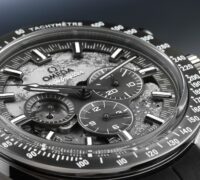 Extreme macro close-up of the skeletonized dial on the Omega Speedmaster Grey Side of the Moon, revealing the cratered texture and exposed mechanical gears.