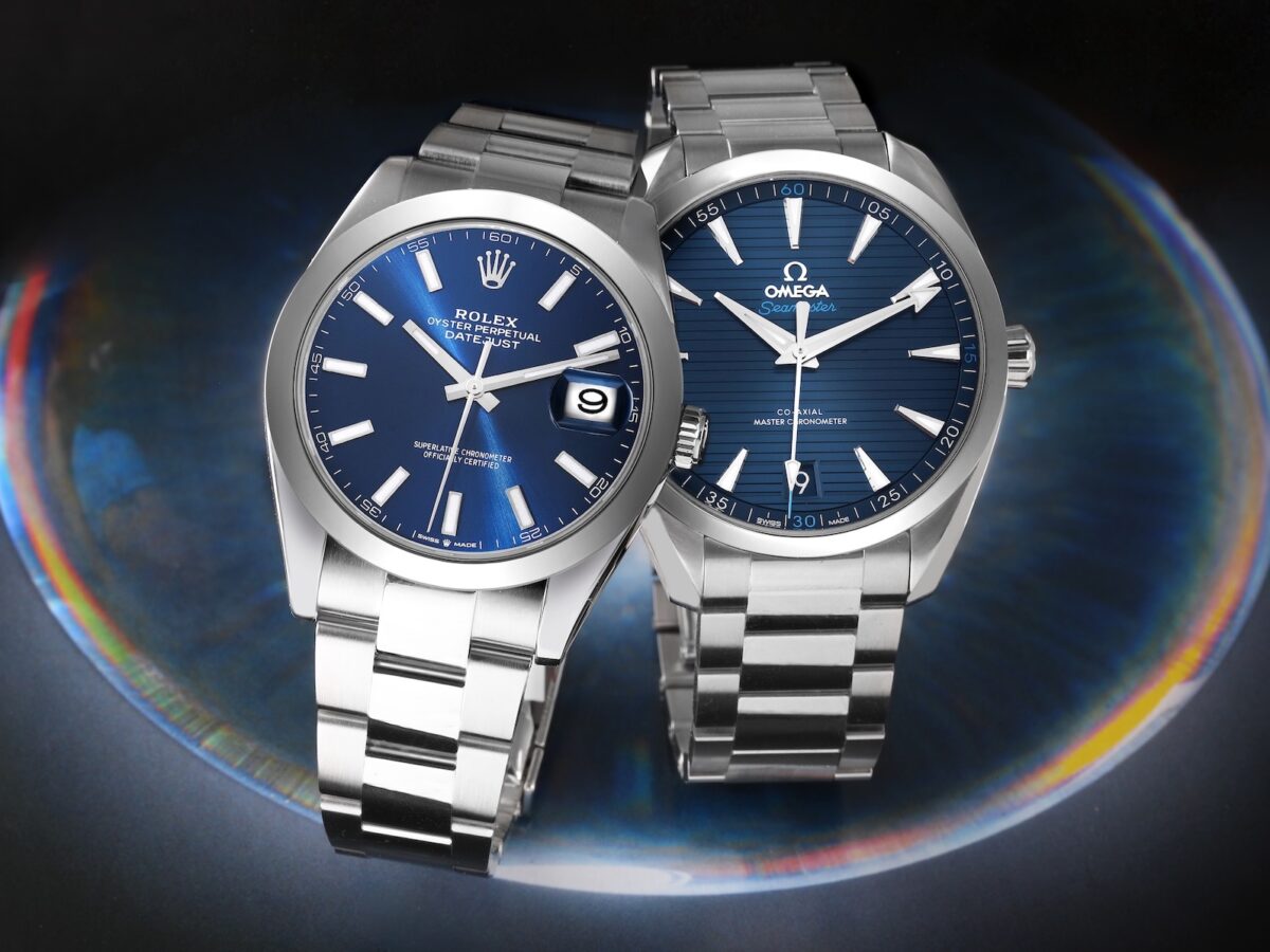 Side-by-side comparison of a stainless steel Rolex Datejust with a blue dial and an Omega Seamaster Aqua Terra with a blue teak dial.
