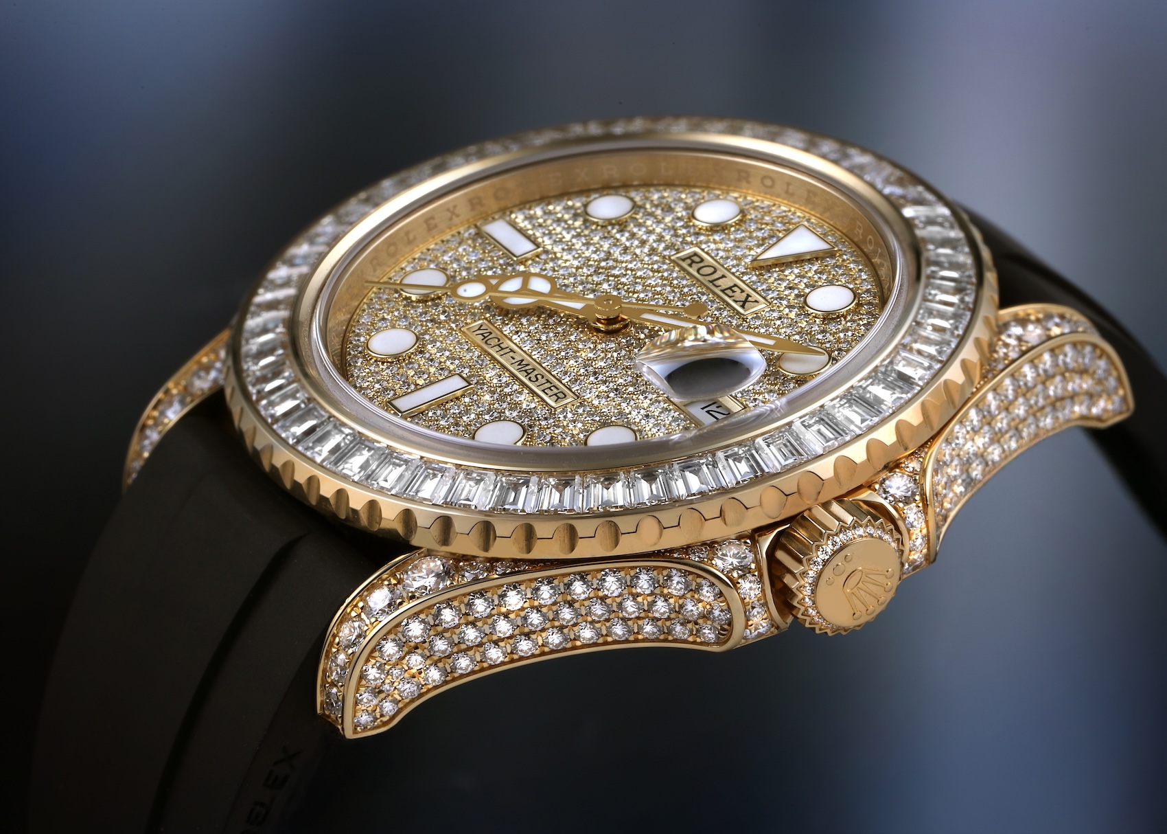 Macro profile view of the Rolex Yacht-Master 42 ref 226668 in 18k yellow gold, showcasing factory diamond-set lugs, crown guards, pave dial, and baguette diamond bezel.