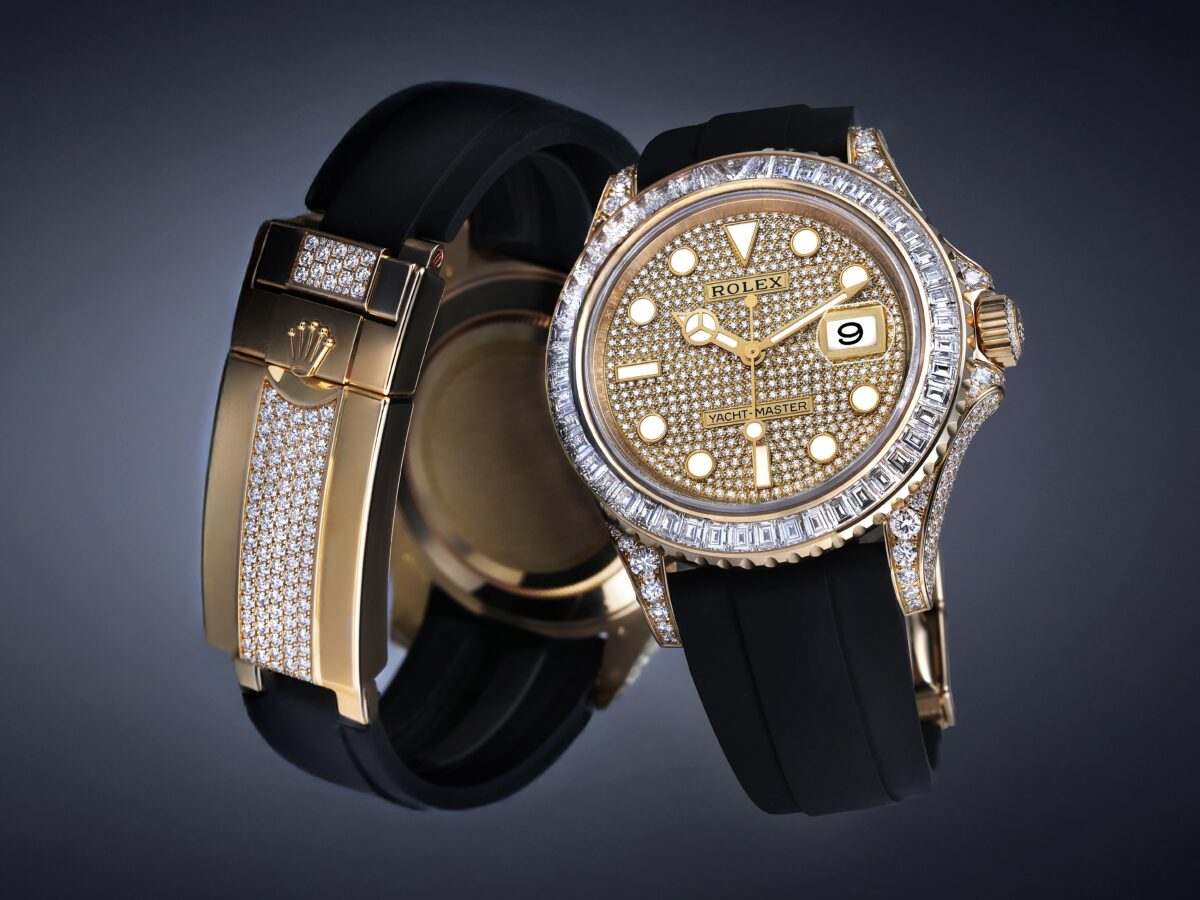 Floating composition of the Rolex Yacht-Master 42 ref 226668 in yellow gold, displaying the diamond pave dial, baguette bezel, and the factory diamond-set Oysterflex folding clasp.