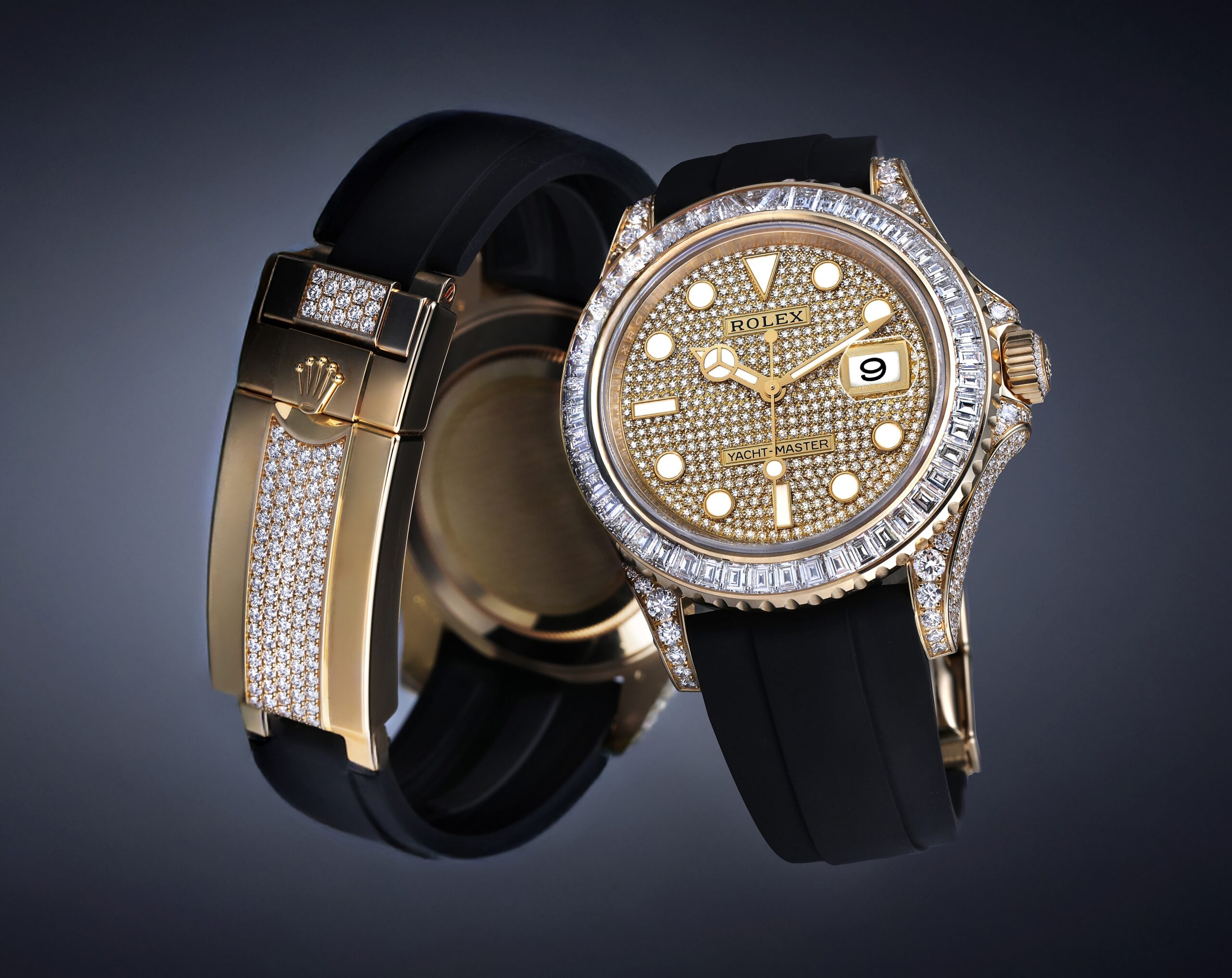 Floating composition of the Rolex Yacht-Master 42 ref 226668 in yellow gold, displaying the diamond pave dial, baguette bezel, and the factory diamond-set Oysterflex folding clasp.