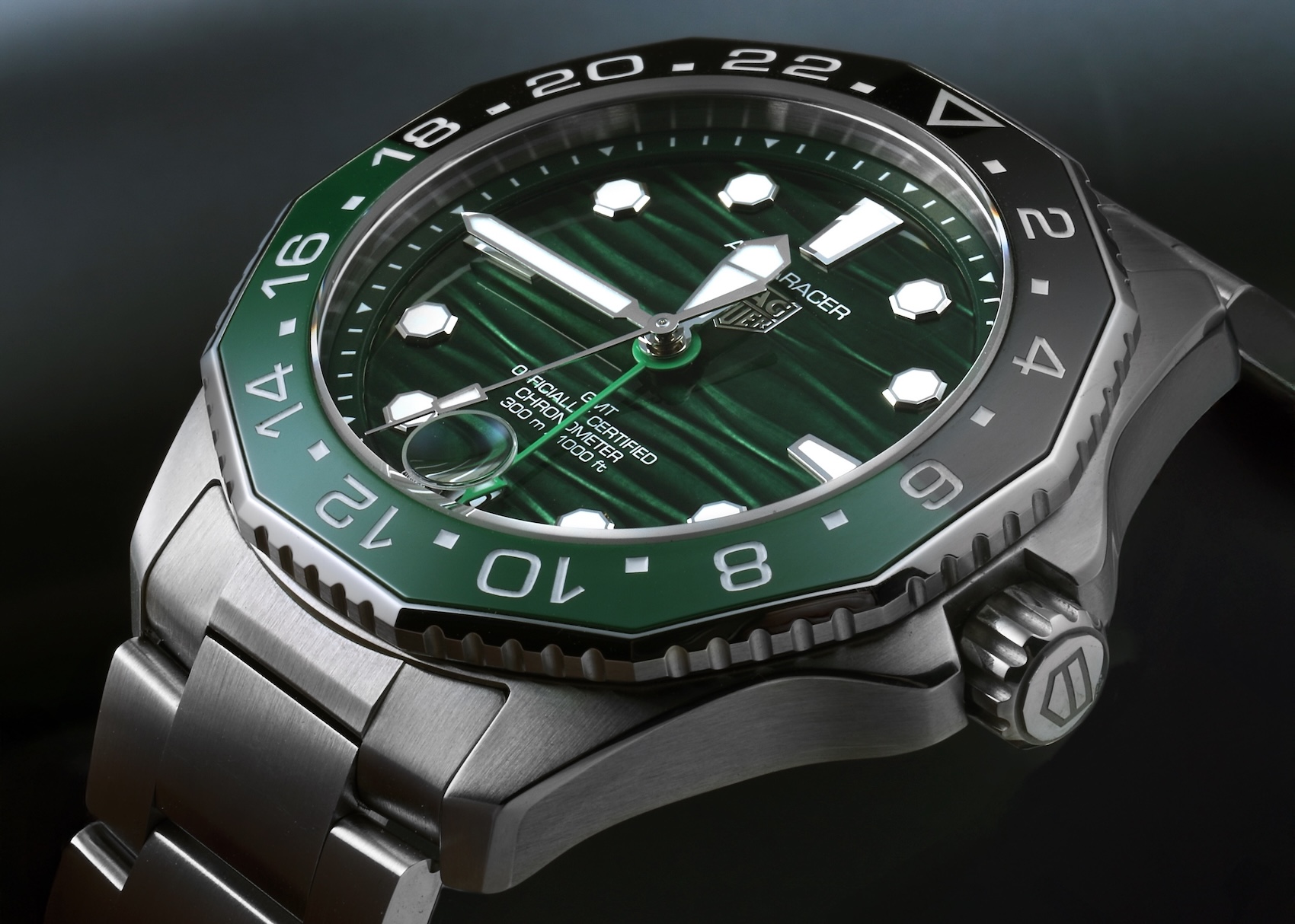 Close-up profile of the TAG Heuer Aquaracer Professional GMT featuring a grooved green dial and a matching green and black ceramic bezel.