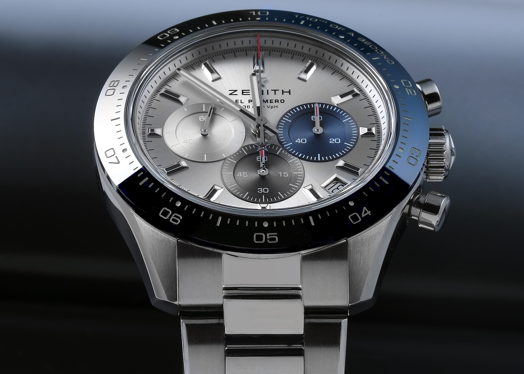 Zenith Chronomaster Sport stainless steel chronograph watch featuring a silver dial, tricolor overlapping subdials, and a blue ceramic bezel.