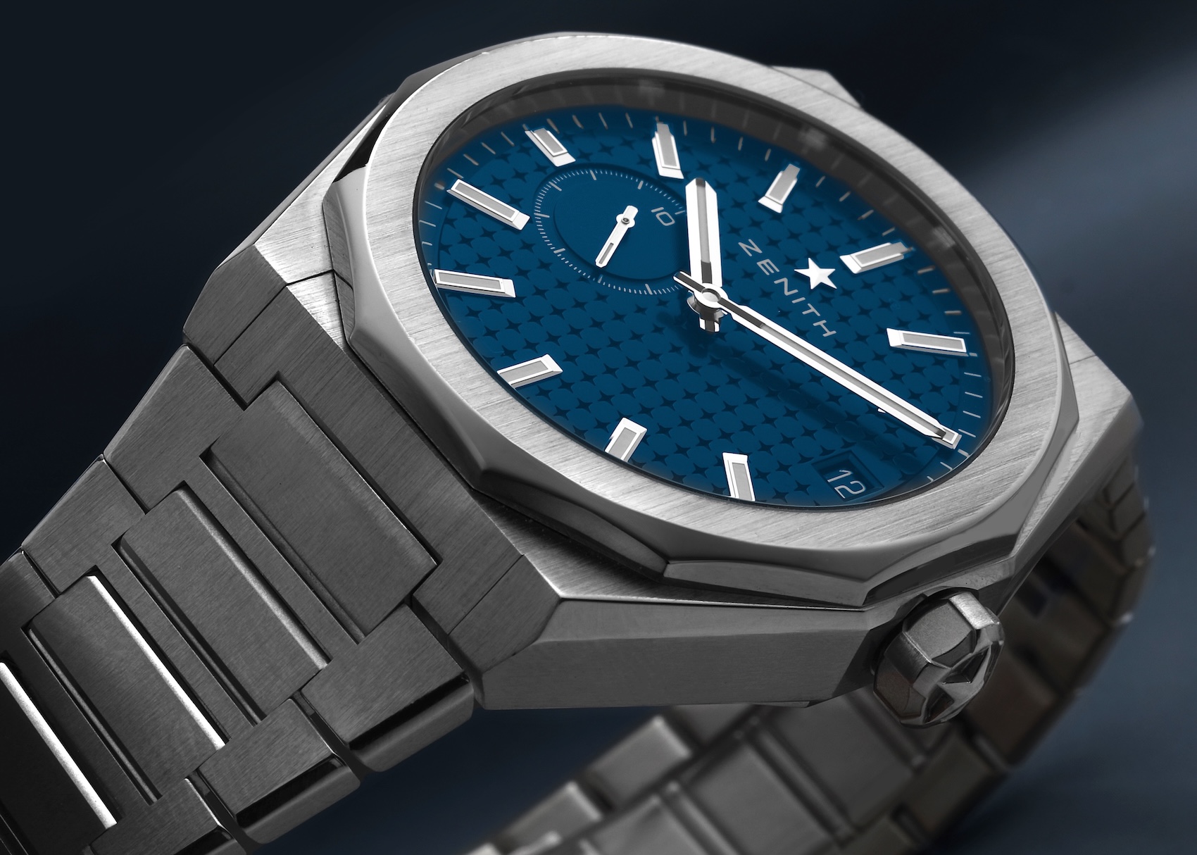 Angle view of a Zenith Defy Skyline 41 watch in steel showing the angular case, textured blue starry dial, small seconds counter at 9, and the faceted integrated bracelet.