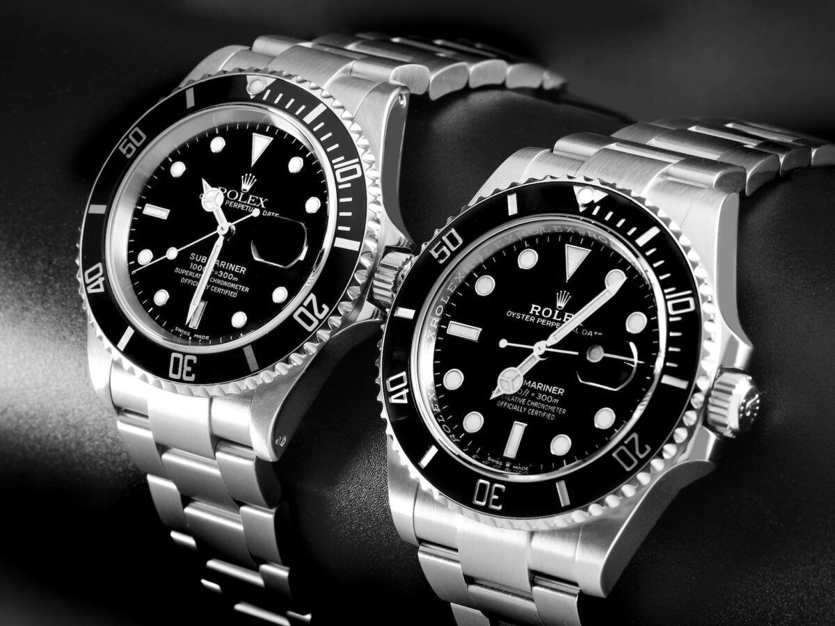Black and white photo of two stainless steel Rolex Submariner watches, a popular luxury sports watch choice for athletes' post-match trophy lift celebrations.