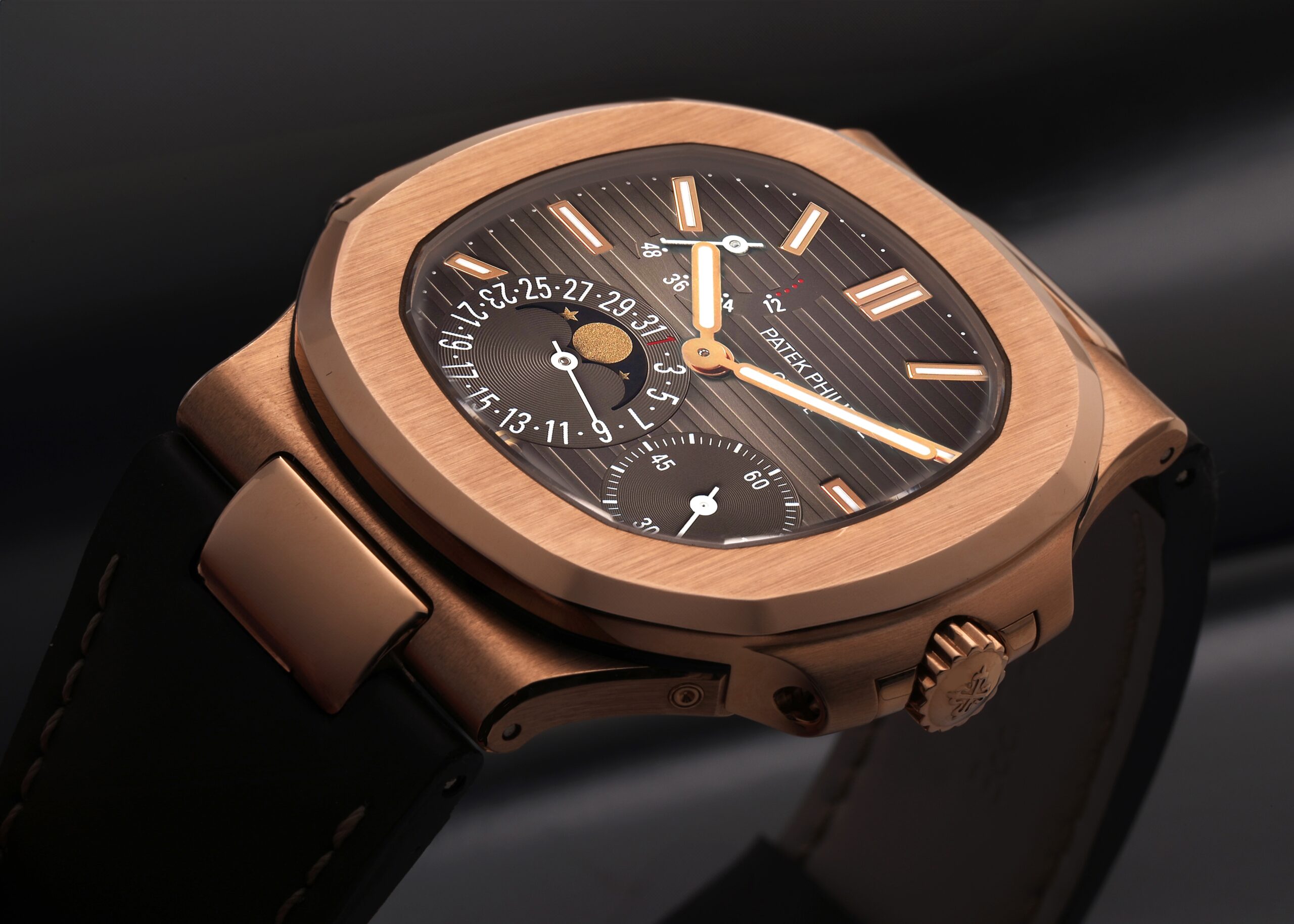 Close-up of the Patek Philippe Nautilus Moonphase in 18k rose gold with a brown dial and black strap, a favorite travel watch of Erling Haaland.