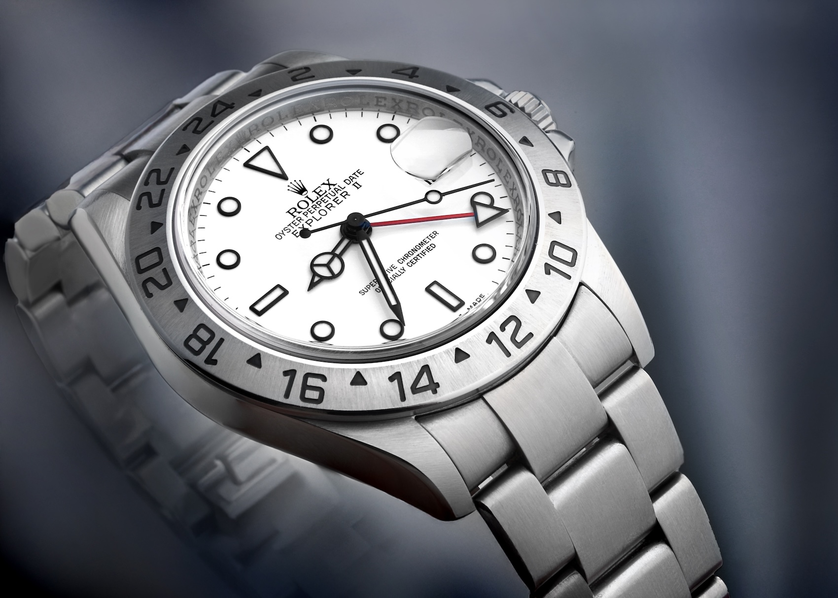 Close up of the Rolex Explorer II 16570 with polar white dial, steel bezel, and red GMT hand.