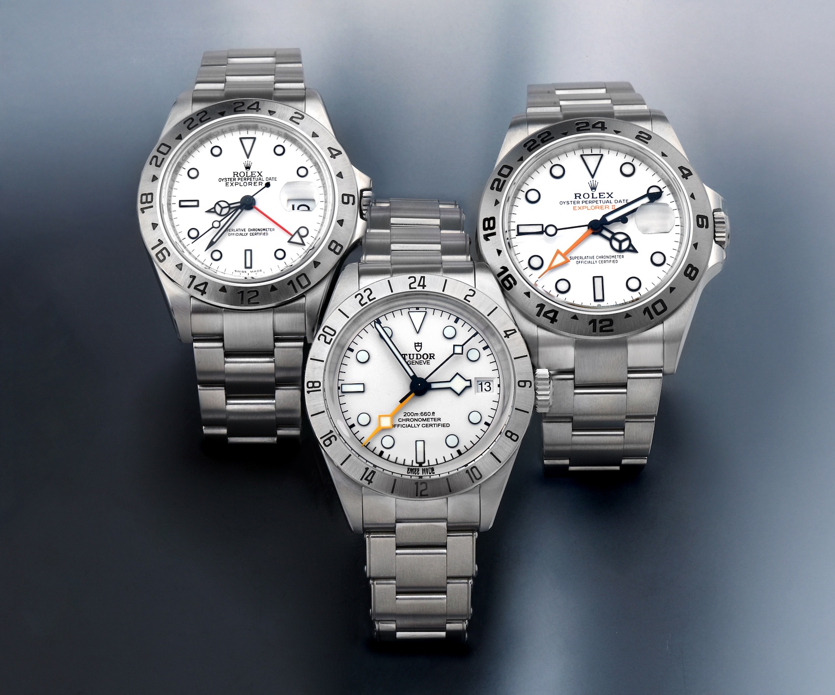 Group shot comparing the Rolex Explorer II 16570, Tudor Black Bay Pro Opaline, and Rolex Explorer II 226570 white dial GMT watches.