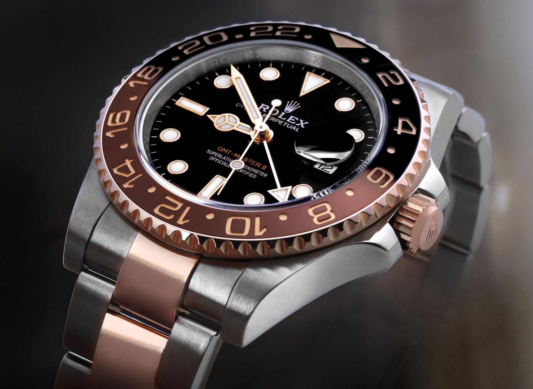 Close up of a Rolex GMT-Master II Root Beer in Oystersteel and Everose gold, reference 126711CHNR, a luxury travel watch ideal for tracking multiple World Cup time zones.