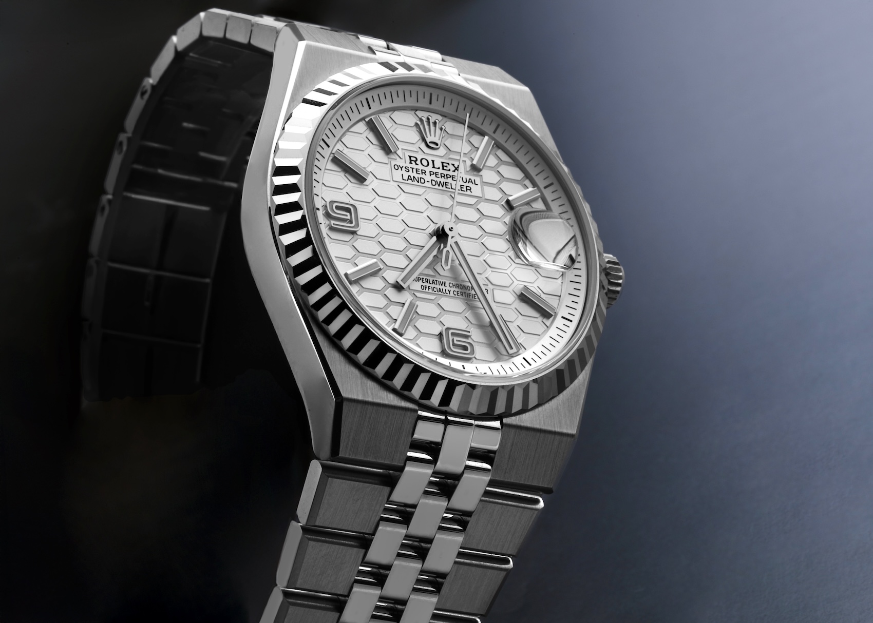 Angled view of the Rolex Land-Dweller 36mm showcasing the integrated flat-link bracelet and sharp case lines.