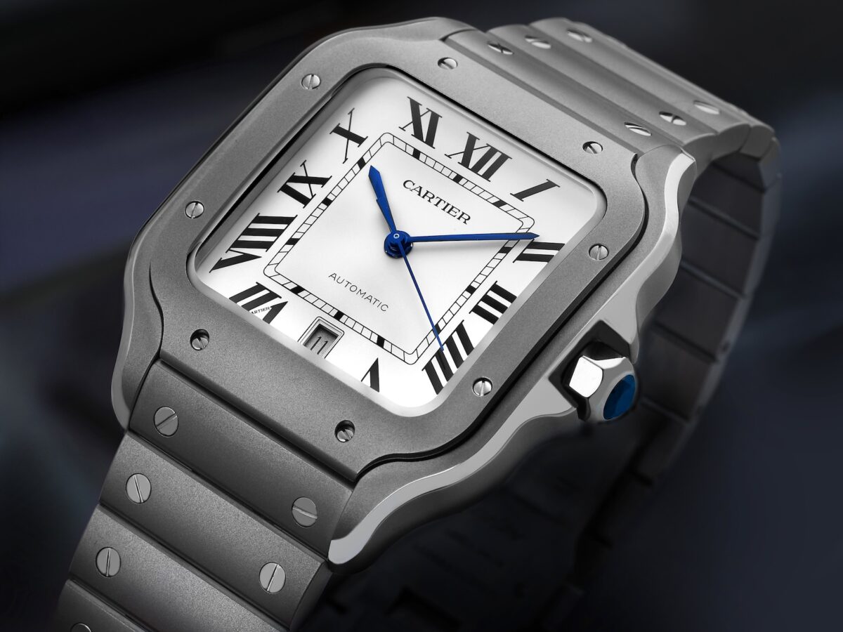 Dramatic angled shot of the Cartier Santos Large Model WSSA0089 in brushed titanium with a silver dial and blued-steel hands.