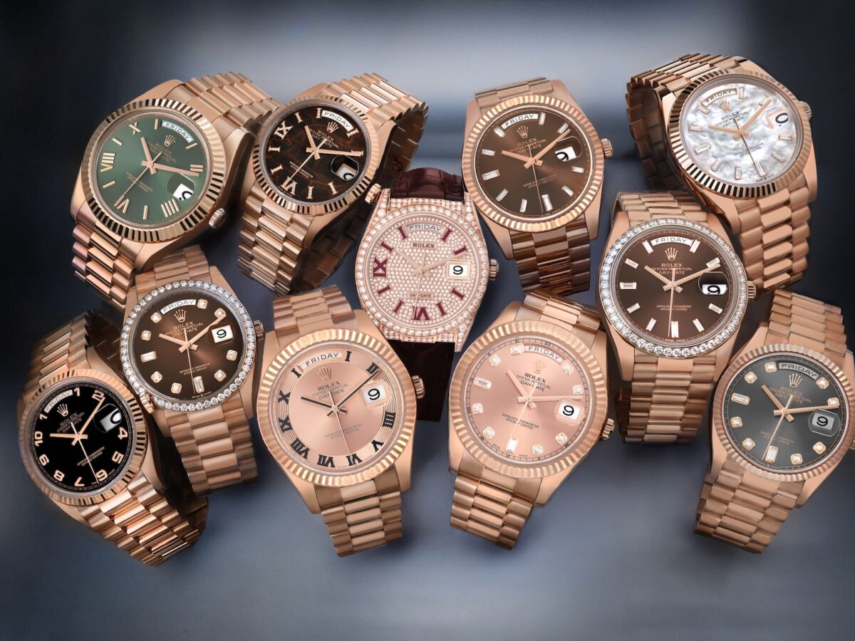 A luxurious collection of nine different Rolex Day-Date watches in 18k Everose gold, displaying a variety of dial configurations including olive green, chocolate, eisenkiesel, and diamond pavé.