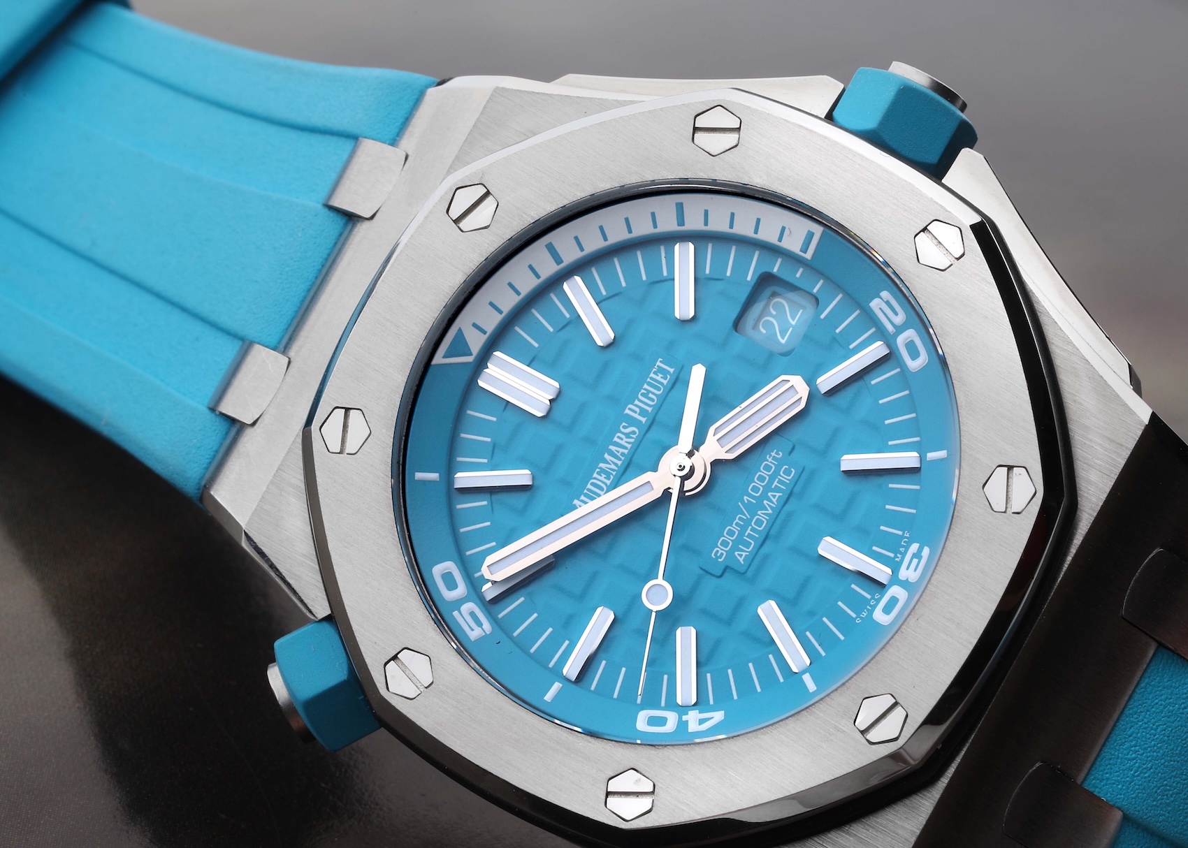 Audemars Piguet Royal Oak Offshore Diver featuring a turquoise Méga Tapisserie dial and matching turquoise rubber strap.
