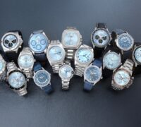Collection of luxury ice blue dial watches from Rolex, Breitling, Tudor, Patek Philippe, Zenith, and Cartier.