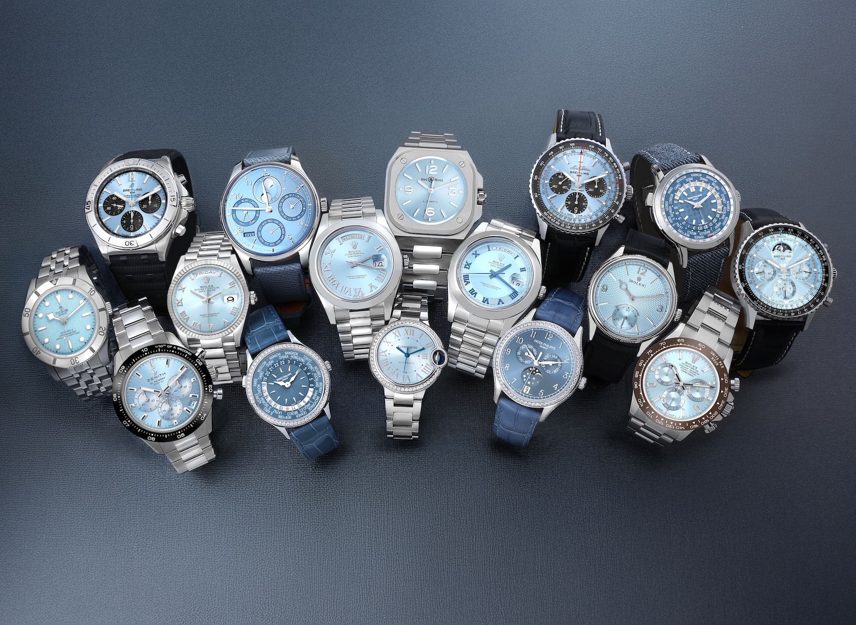 Collection of luxury ice blue dial watches from Rolex, Breitling, Tudor, Patek Philippe, Zenith, and Cartier.