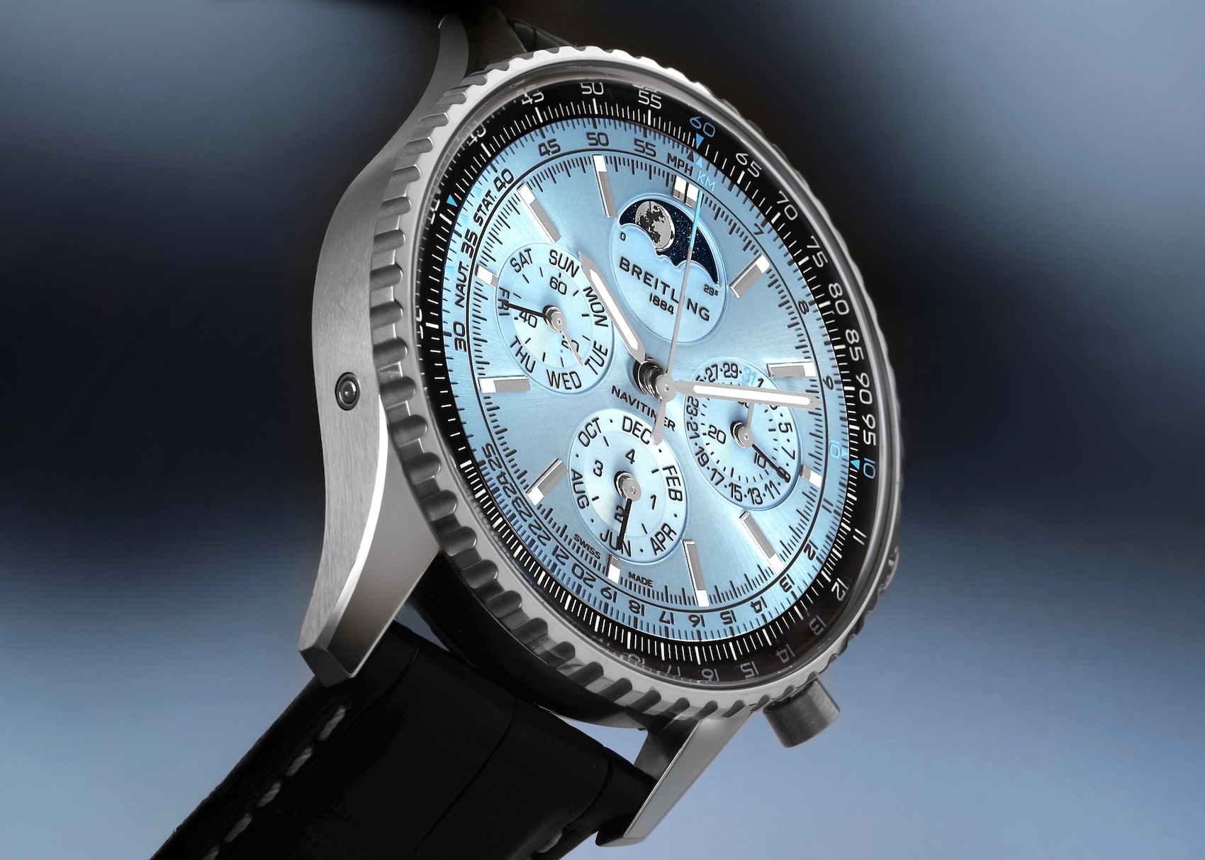 Detailed angle shot of the Breitling Navitimer B19 Perpetual Calendar featuring an ice blue dial and slide rule bezel.