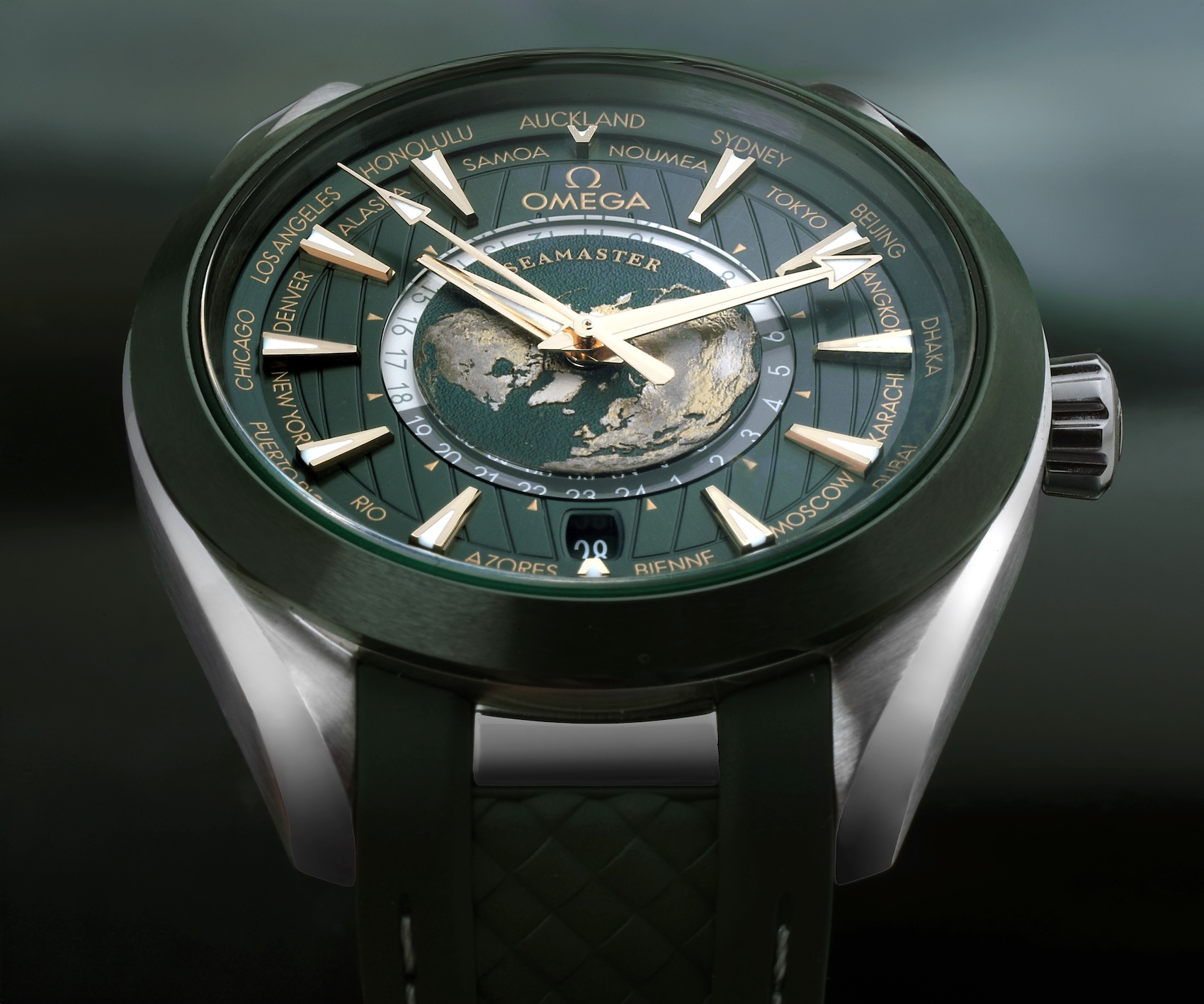 Close-up of the green dial on the Omega Seamaster Aqua Terra Worldtimer watch featuring a laser-ablated titanium topographical map of the Earth.