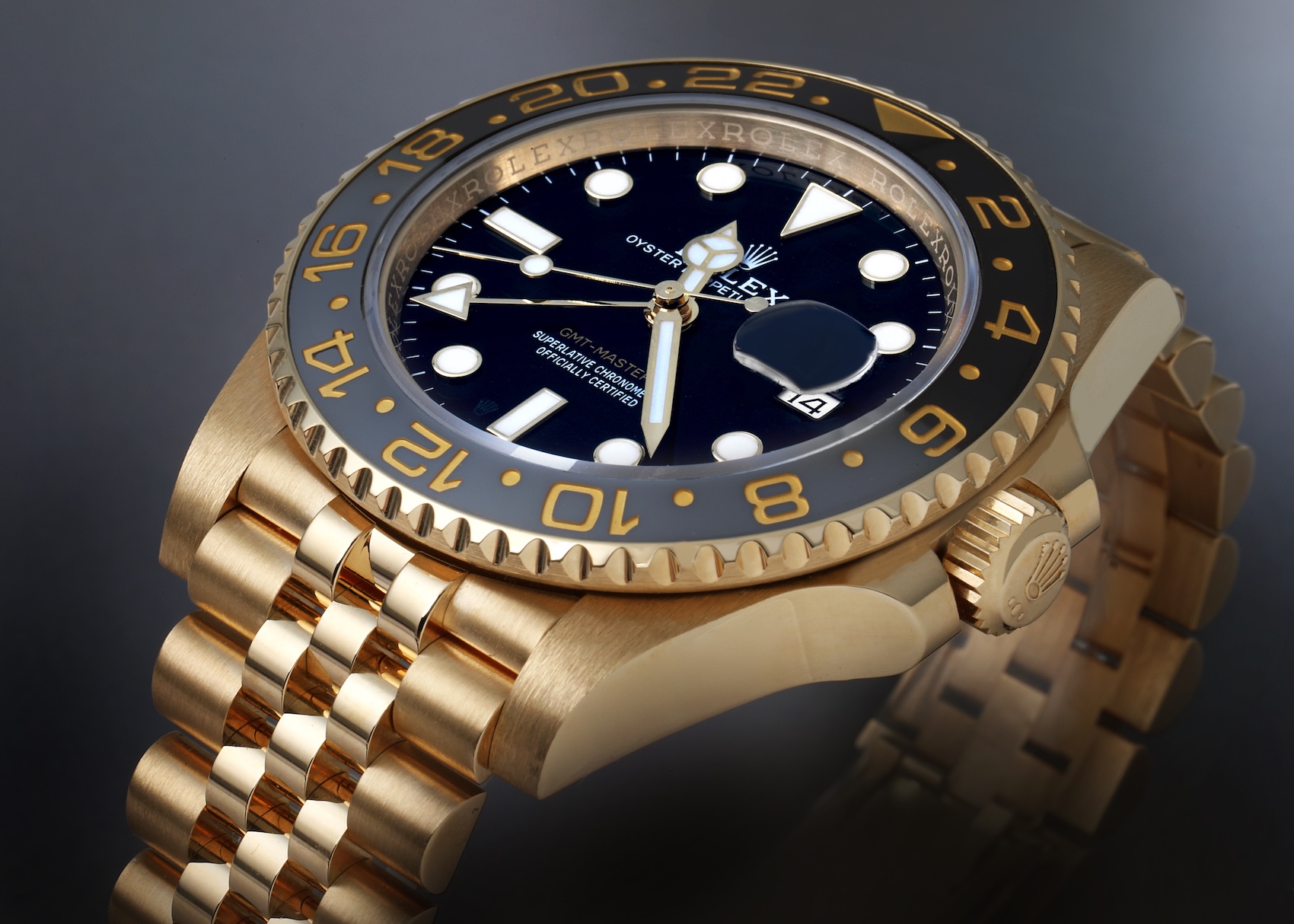 Close-up of the black dial and black and grey bezel on the 18k yellow gold Rolex GMT-Master II 126718GRNR Zombie