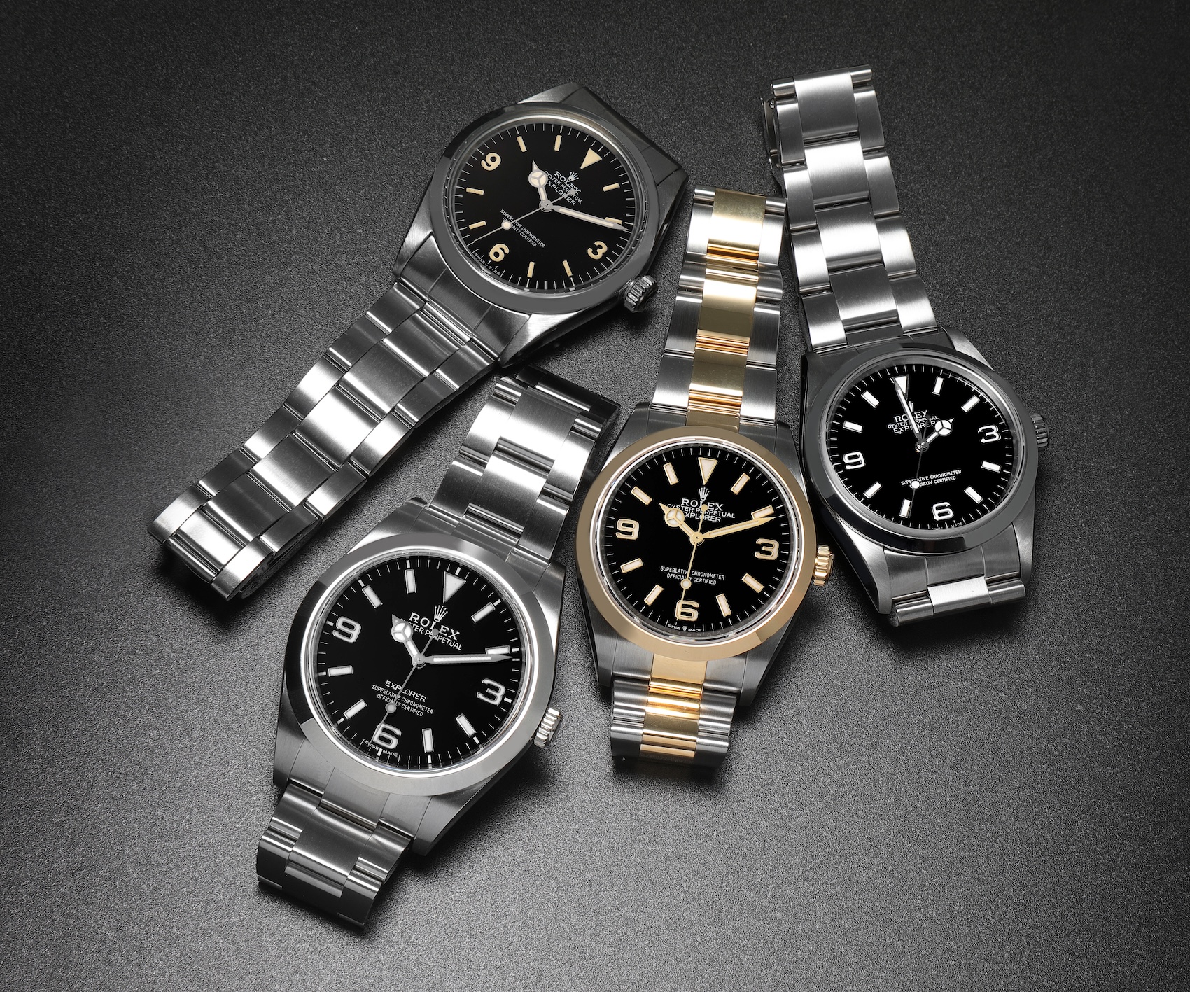 Comparison of the two-tone Rolex Explorer 124273 surrounded by three stainless steel Rolex Explorer watches