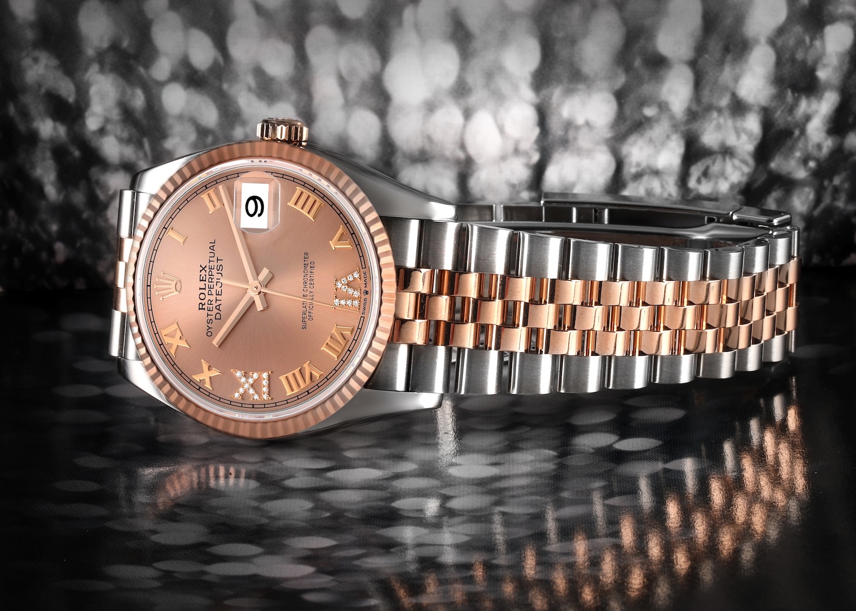 Rolesor Rolex Datejust 36 reference 126231 in steel and Everose gold, featuring a sundust dial with Roman numerals and a diamond-set VI marker.