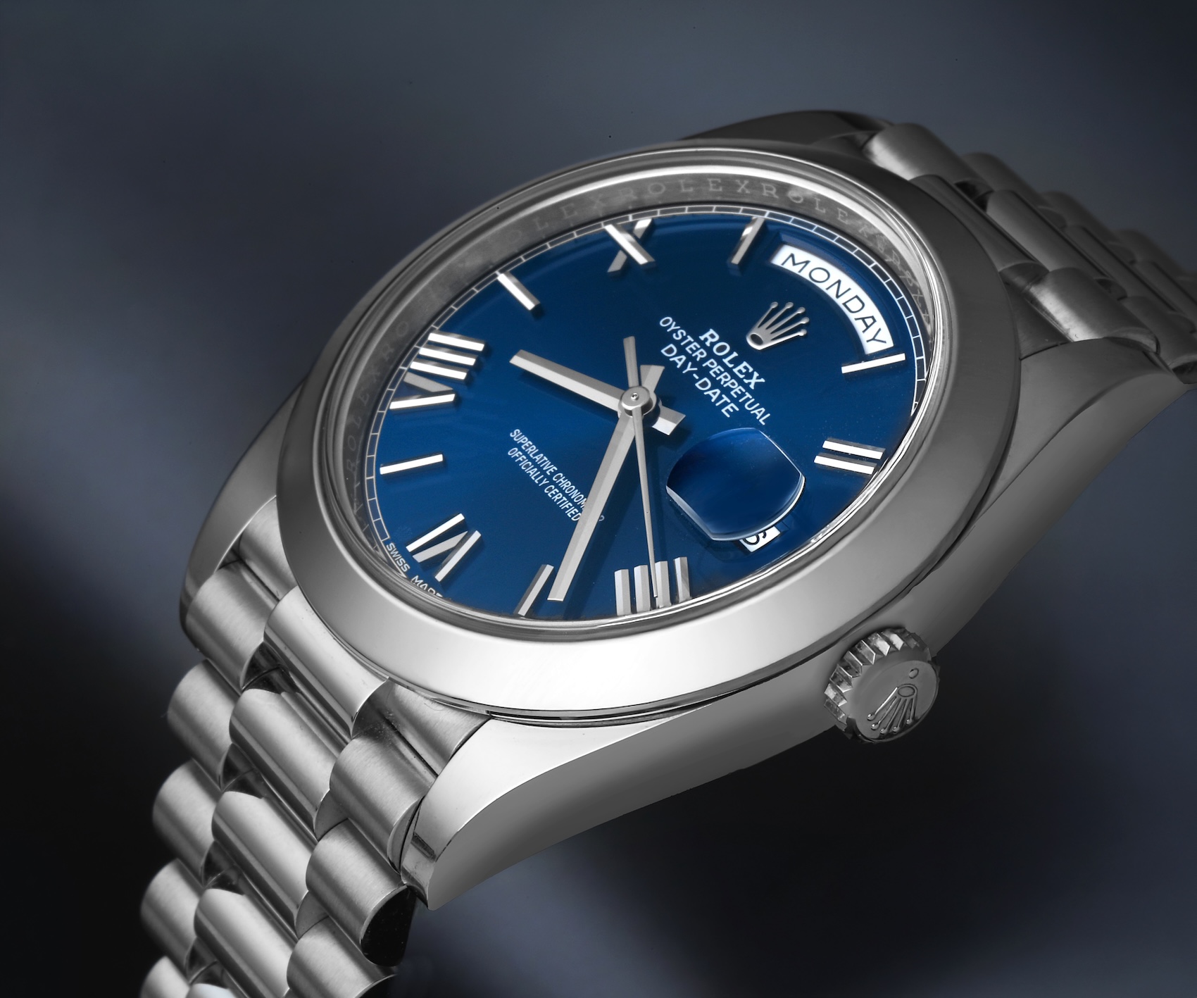 Platinum Rolex Day-Date 40 reference 228206 featuring a blue dial with classic applied Roman numerals and a smooth bezel.